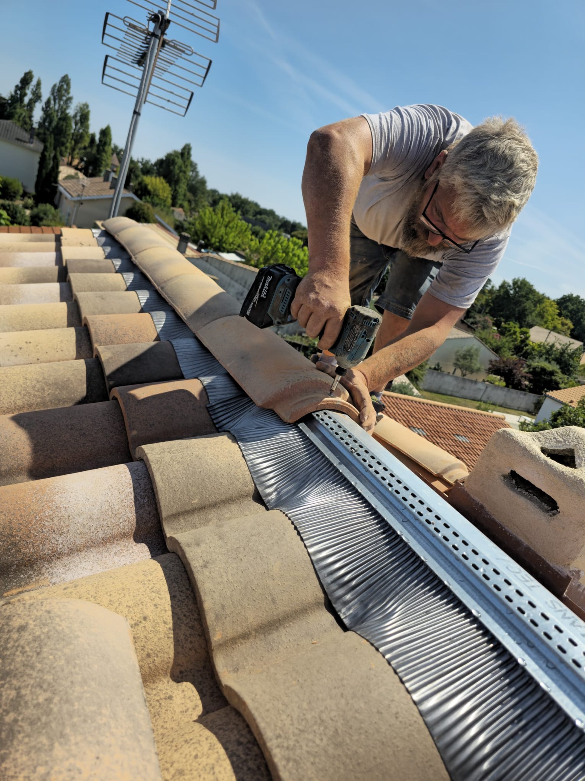 a person wearing blue gloves and holding a hammer