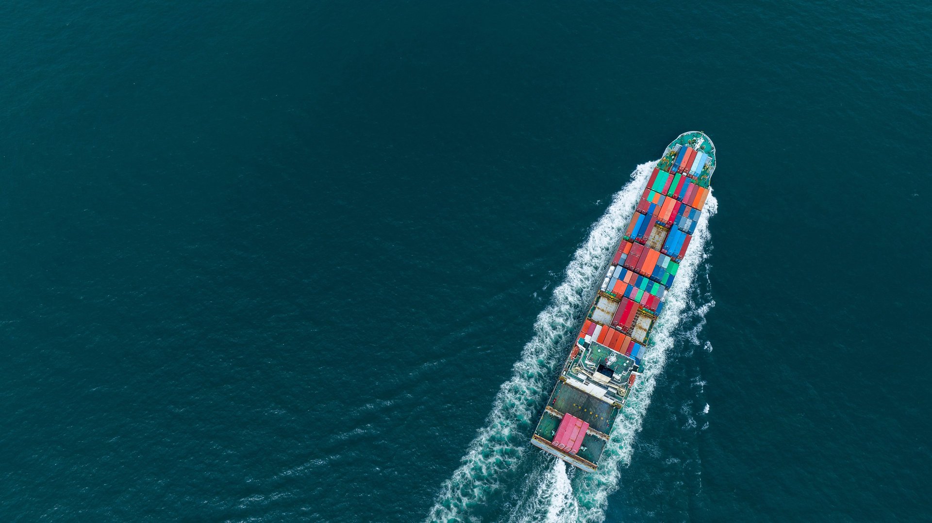 aerial view of blue and white boat on body of water during daytime