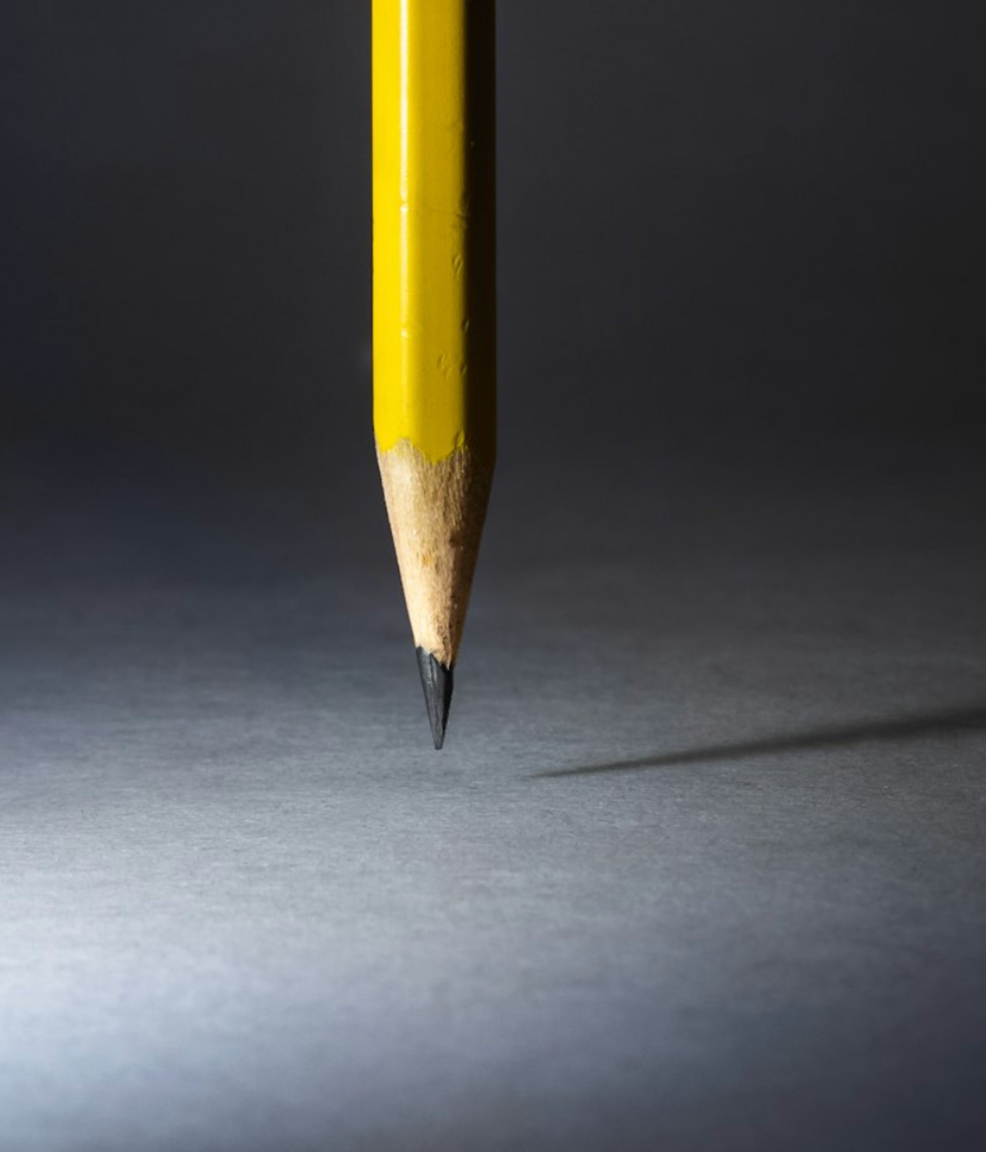a yellow pencil with a black background
