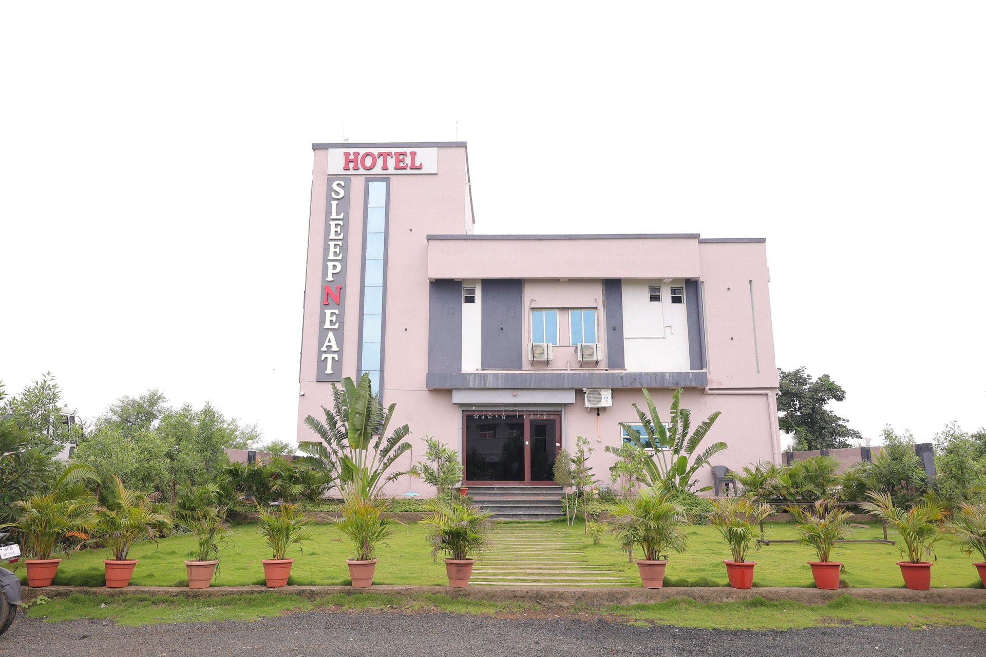 low-angle photo of Hotel lighted signage on top of brown building during nighttime