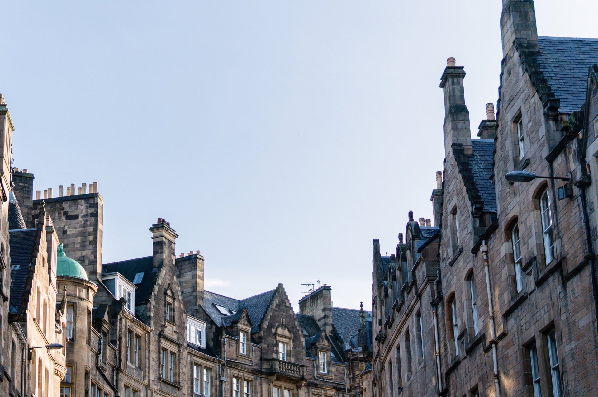 an abstract photo of a curved building with a blue sky in the background