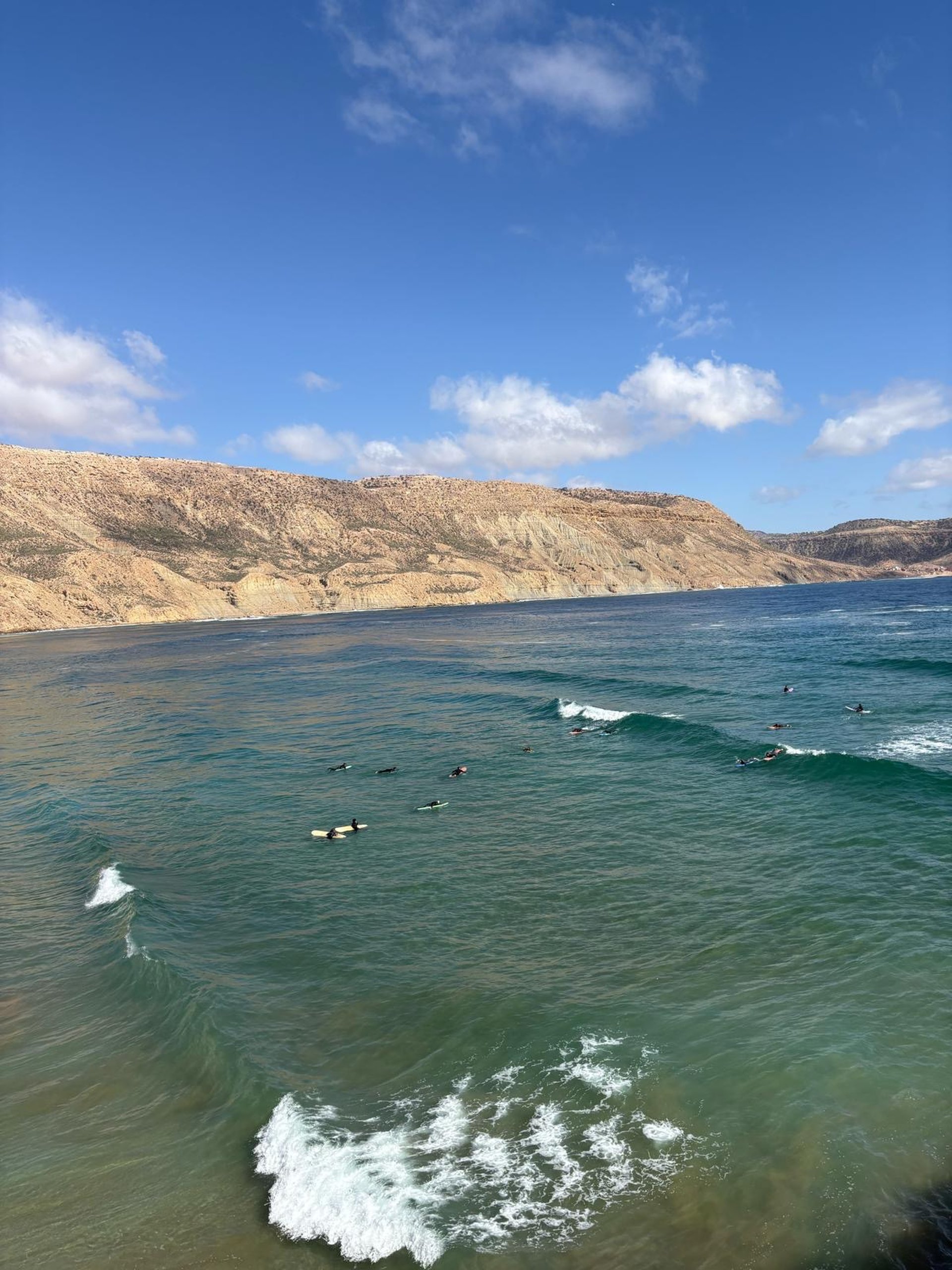 woman wearing yellow long-sleeved dress under white clouds and blue sky during daytime