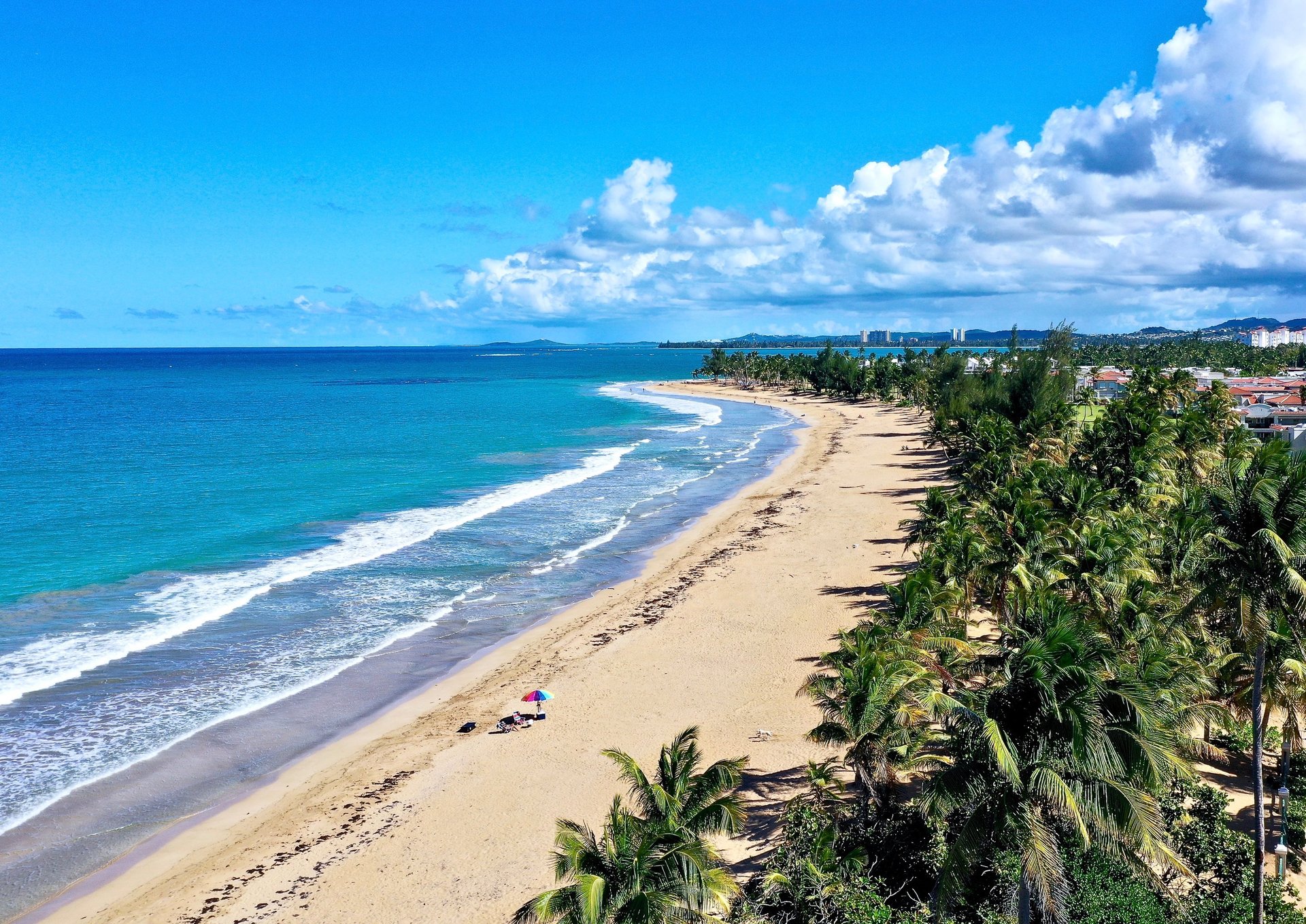 woman wearing yellow long-sleeved dress under white clouds and blue sky during daytime