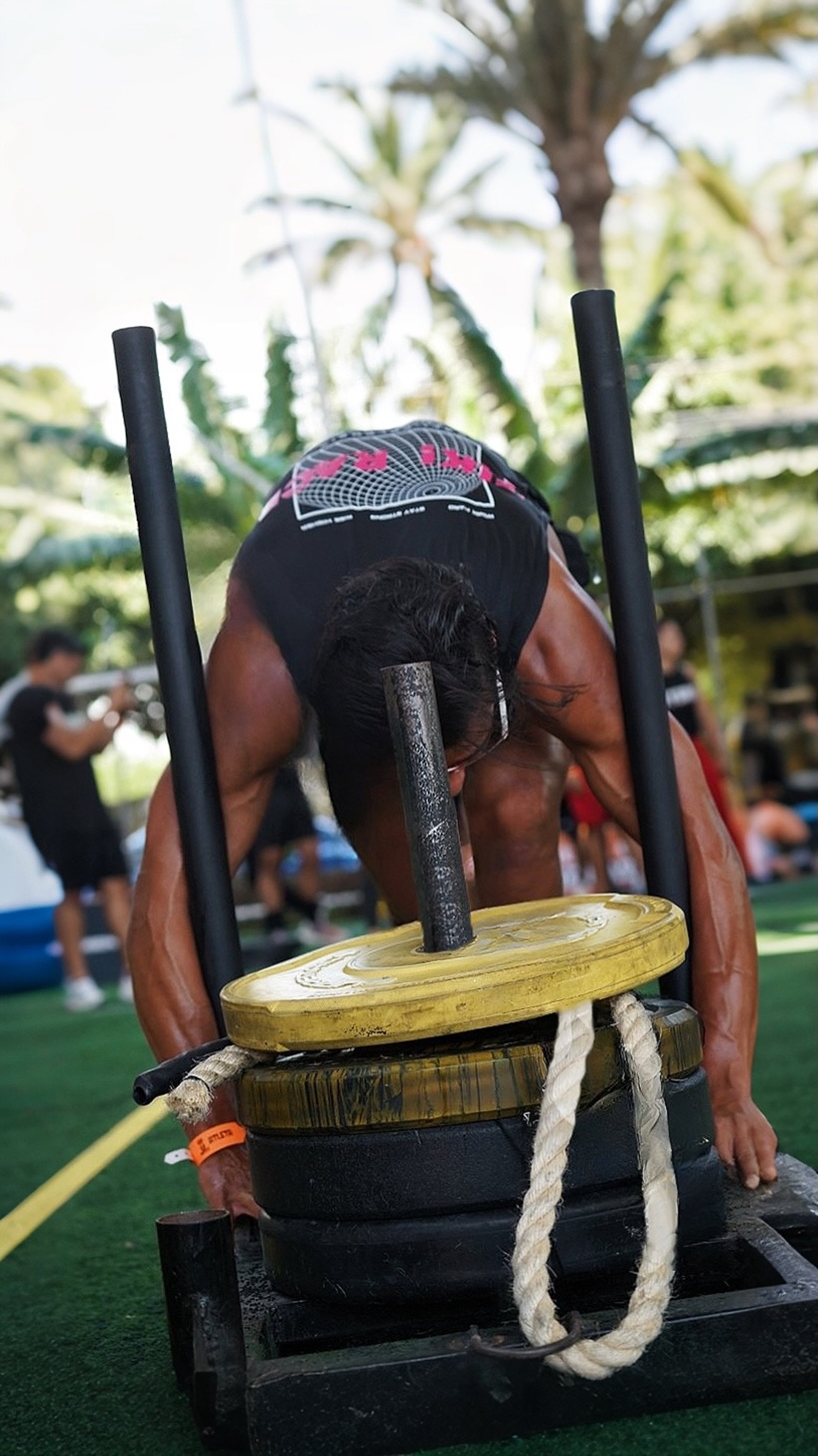 topless man using rowing machine