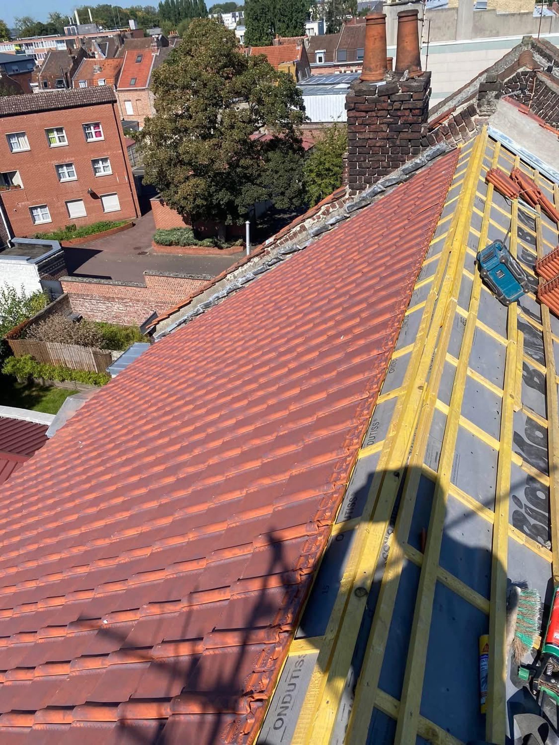 a person wearing blue gloves and holding a hammer