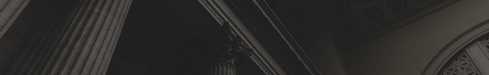 Grand building facade with illuminated classical columns