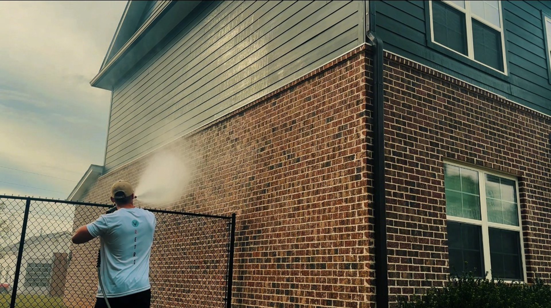 man in yellow jacket standing near gas pump