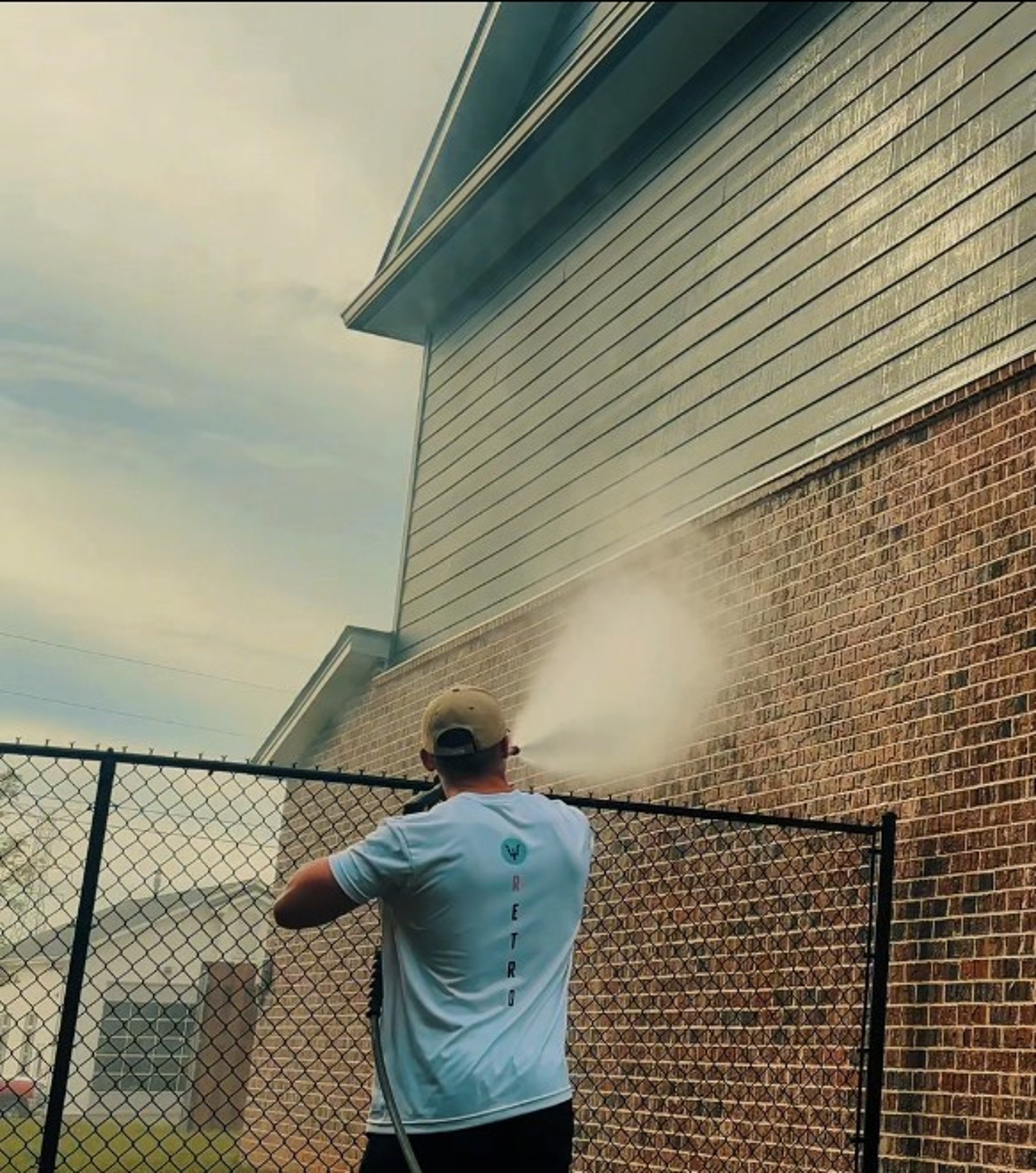 man in yellow jacket standing near gas pump
