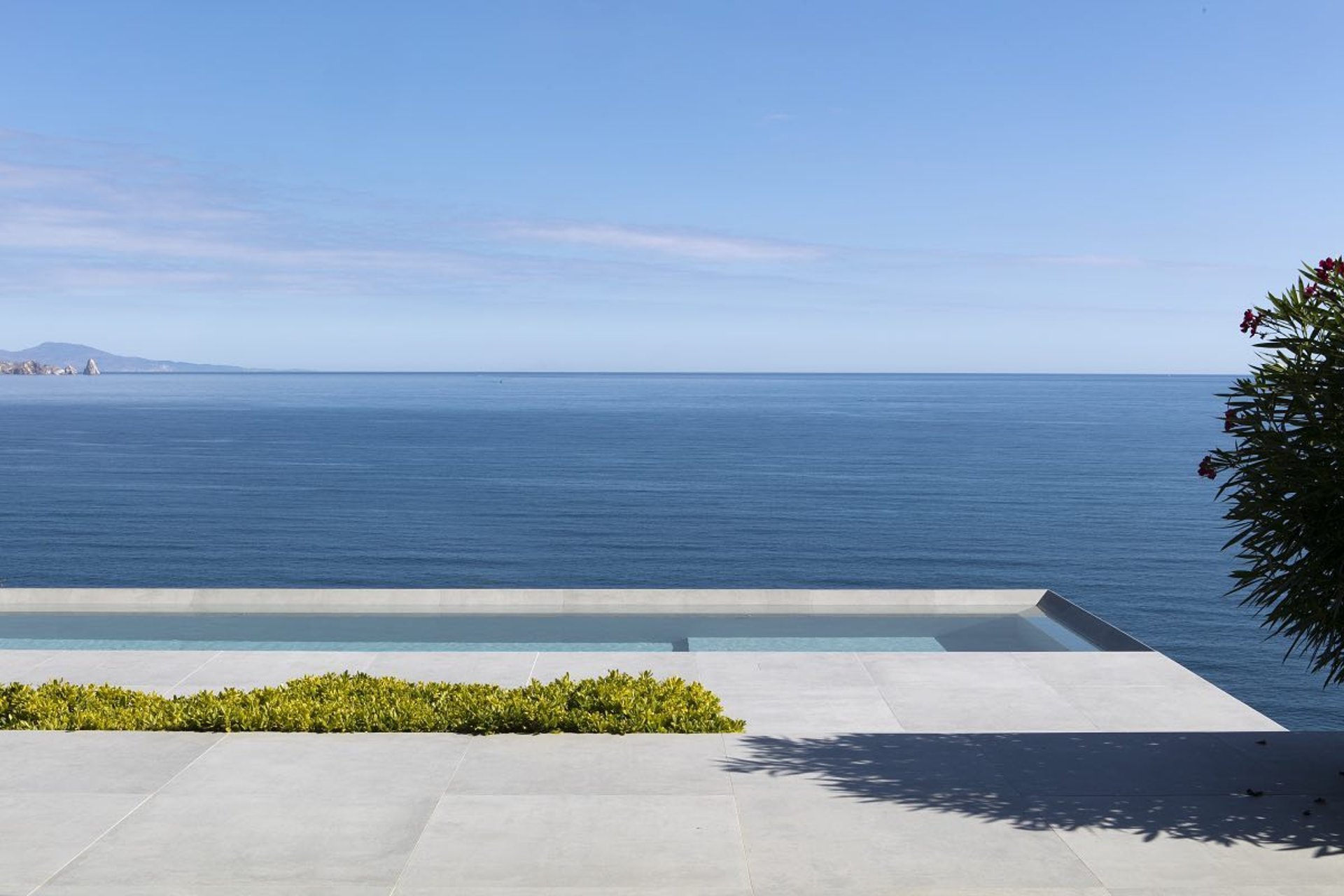 an abstract photo of a curved building with a blue sky in the background