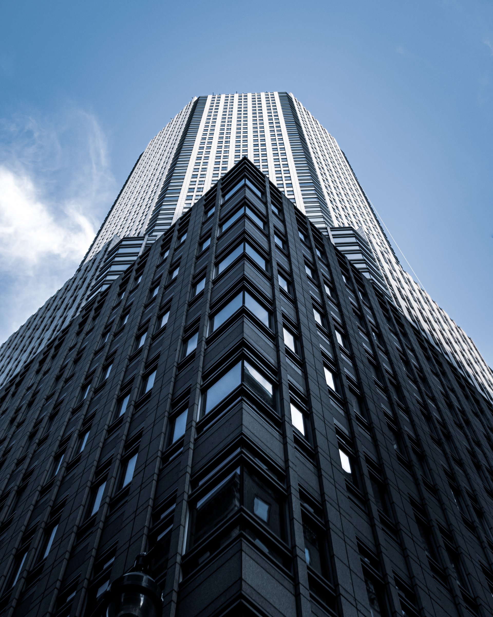 an abstract photo of a curved building with a blue sky in the background