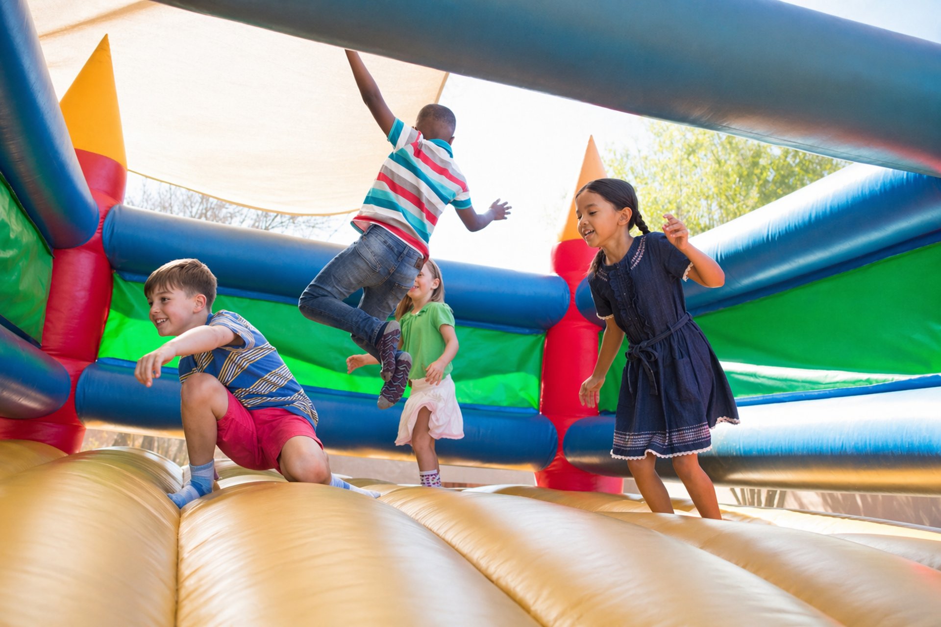 A young boy jumping on a bouncy castle