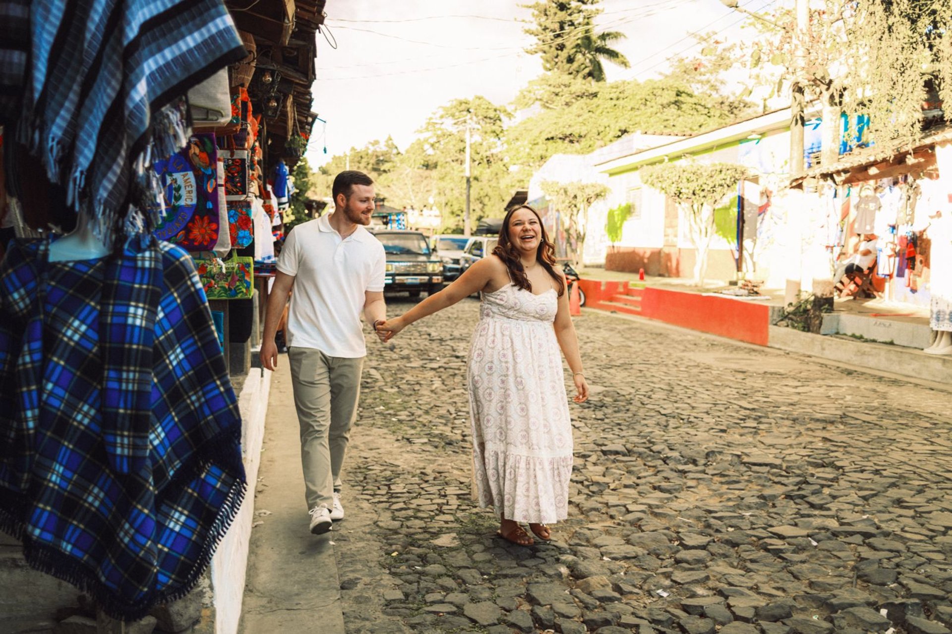 man and woman standing in front of brown concrete building during daytime