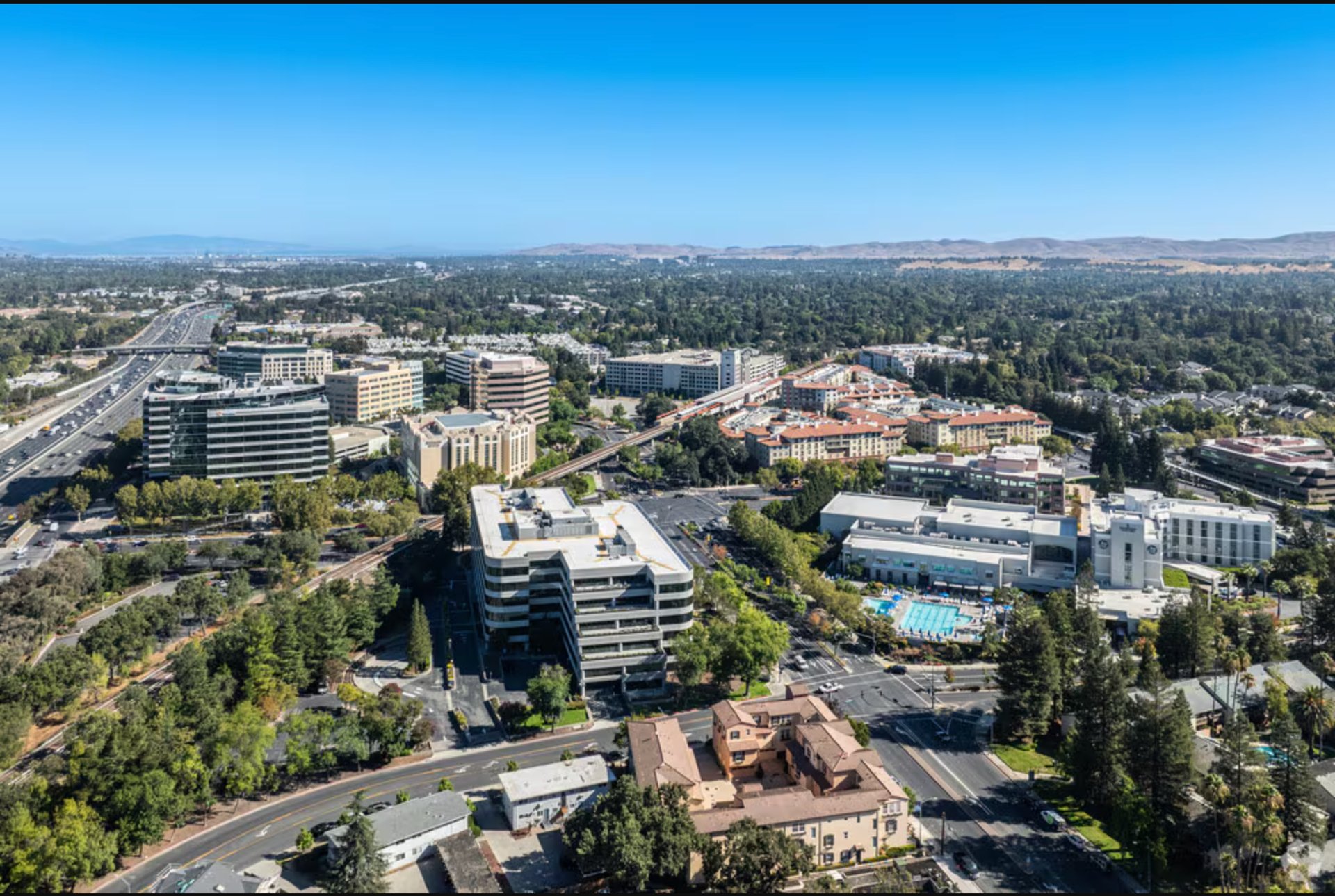 an abstract photo of a curved building with a blue sky in the background