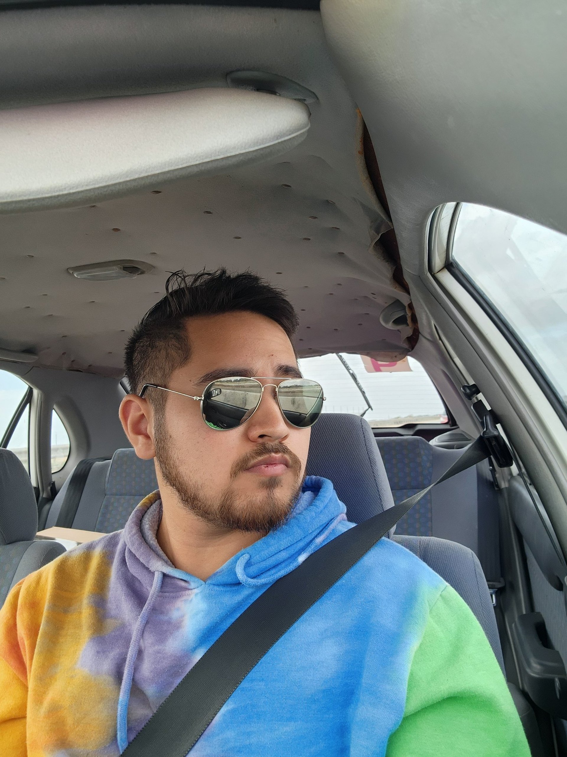 an abstract photo of a curved building with a blue sky in the background