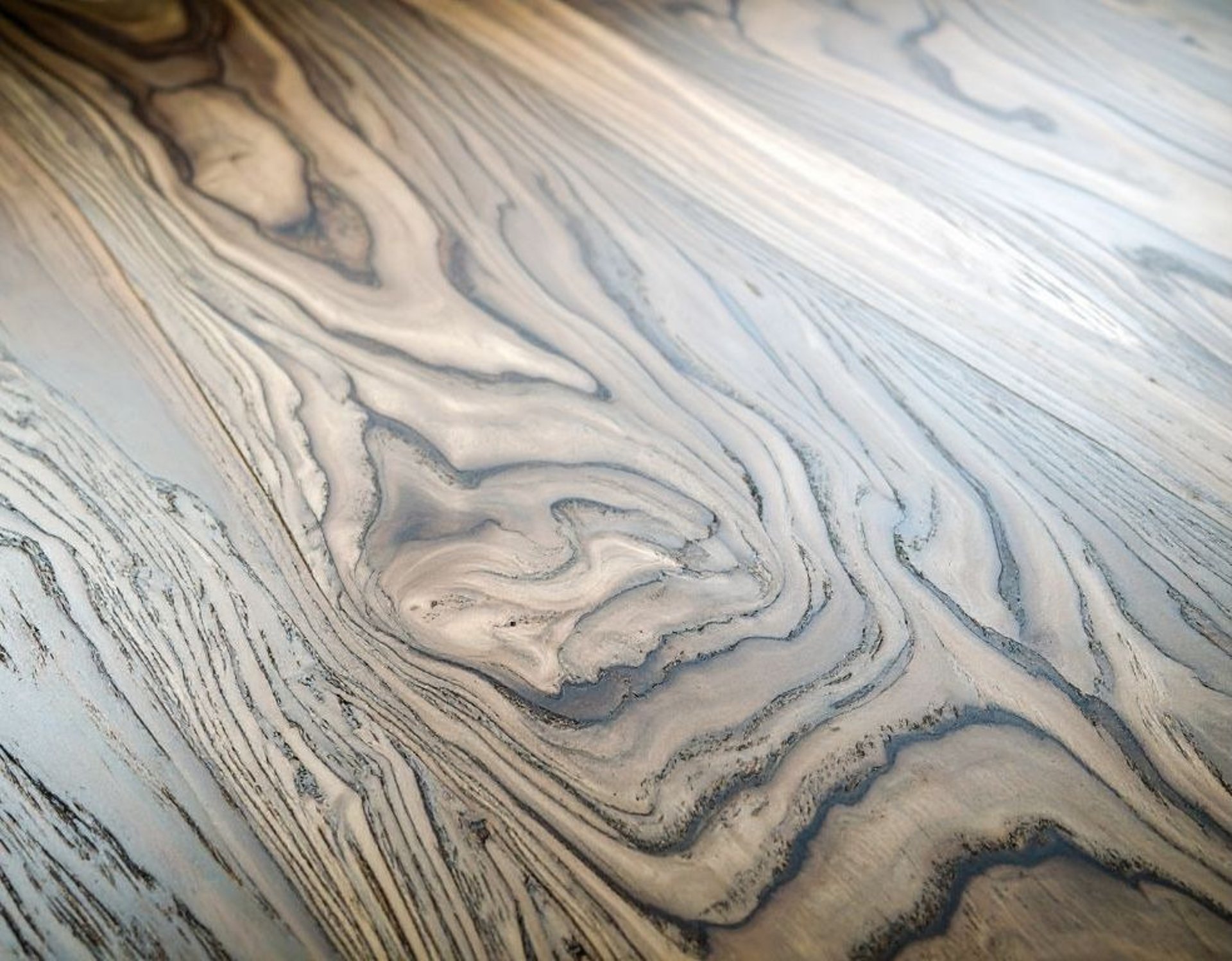 an abstract photo of a curved building with a blue sky in the background