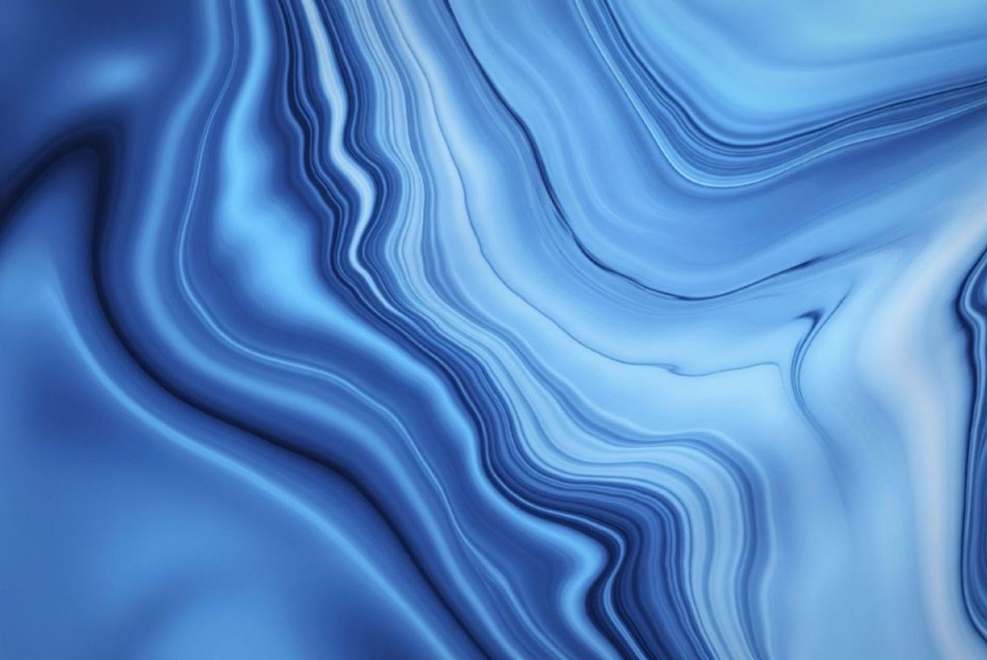 an abstract photo of a curved building with a blue sky in the background