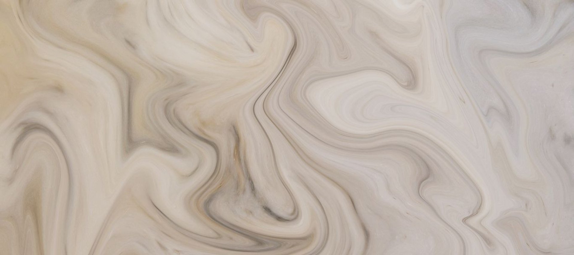 an abstract photo of a curved building with a blue sky in the background