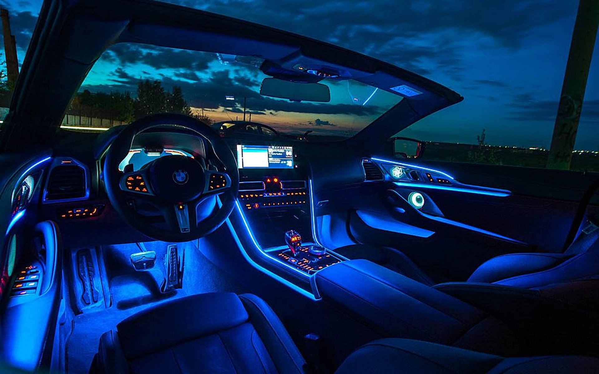 Car dashboard displaying navigation and music apps.