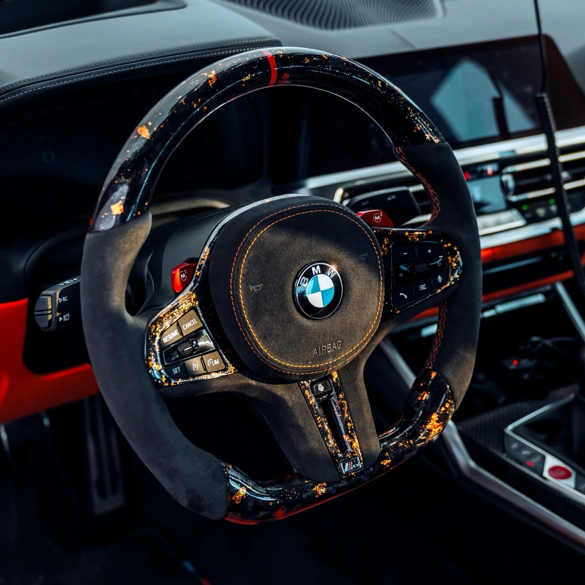 Car dashboard displaying navigation and music apps.