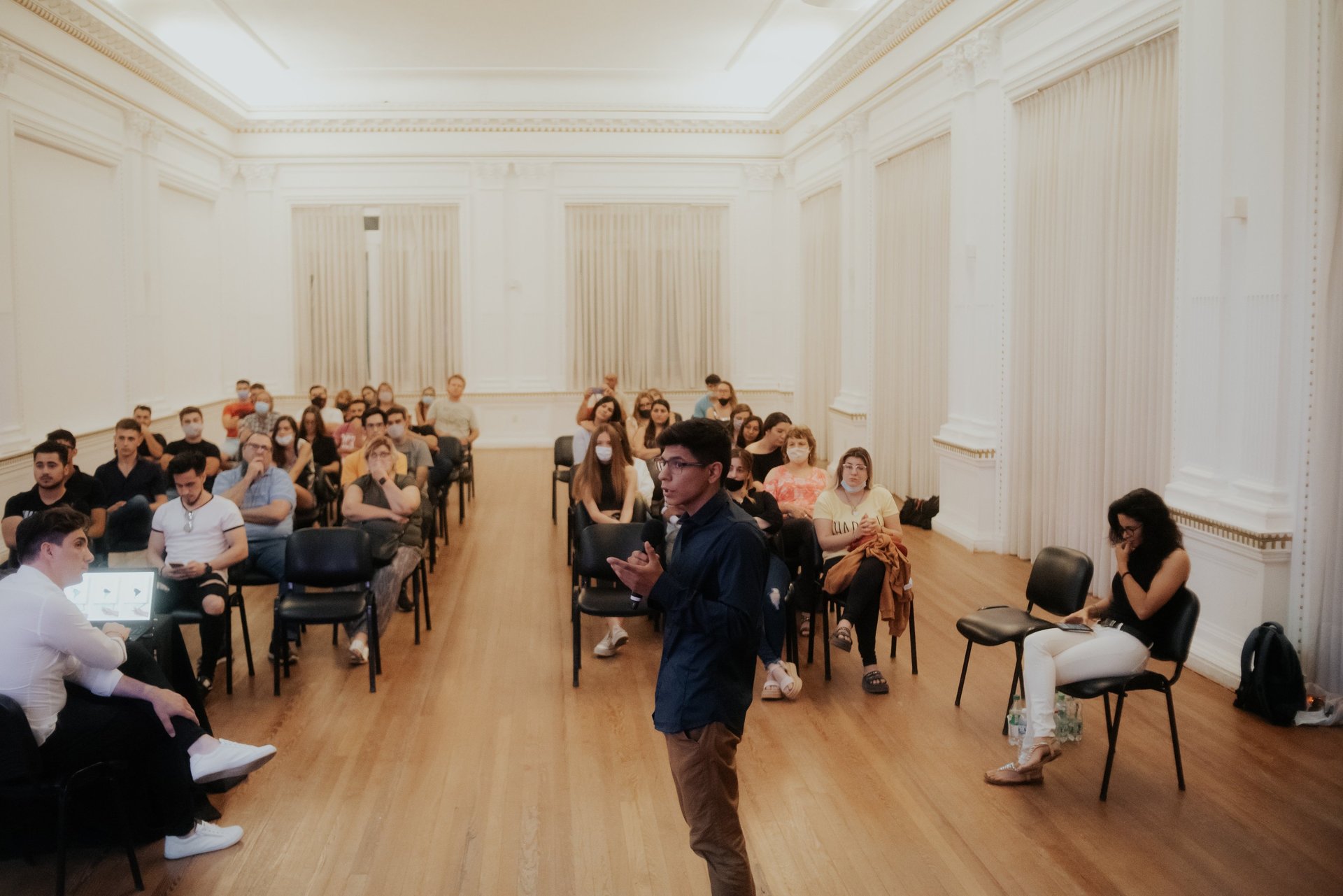 grayscale photo of people walking towards building