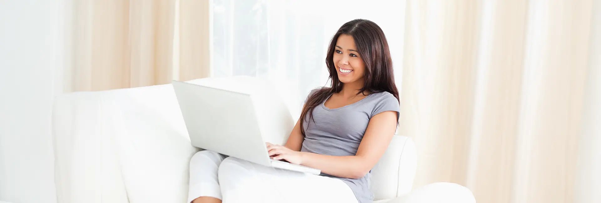a woman sitting at a desk with a keyboard and mouse