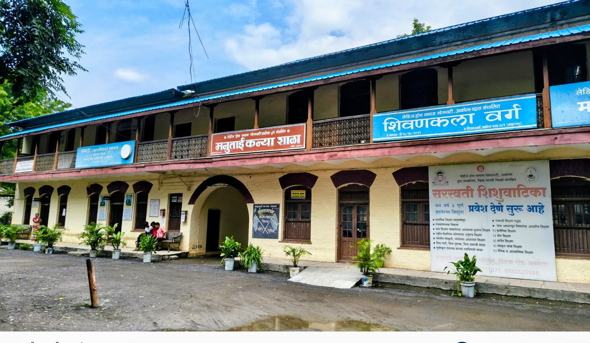 silhouette of three people up on mountain cliff