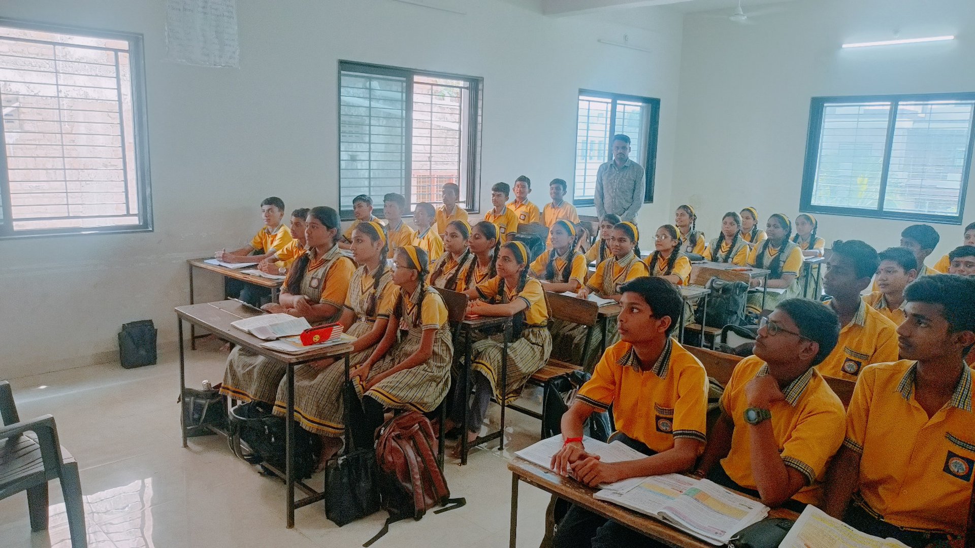 silhouette of three people up on mountain cliff
