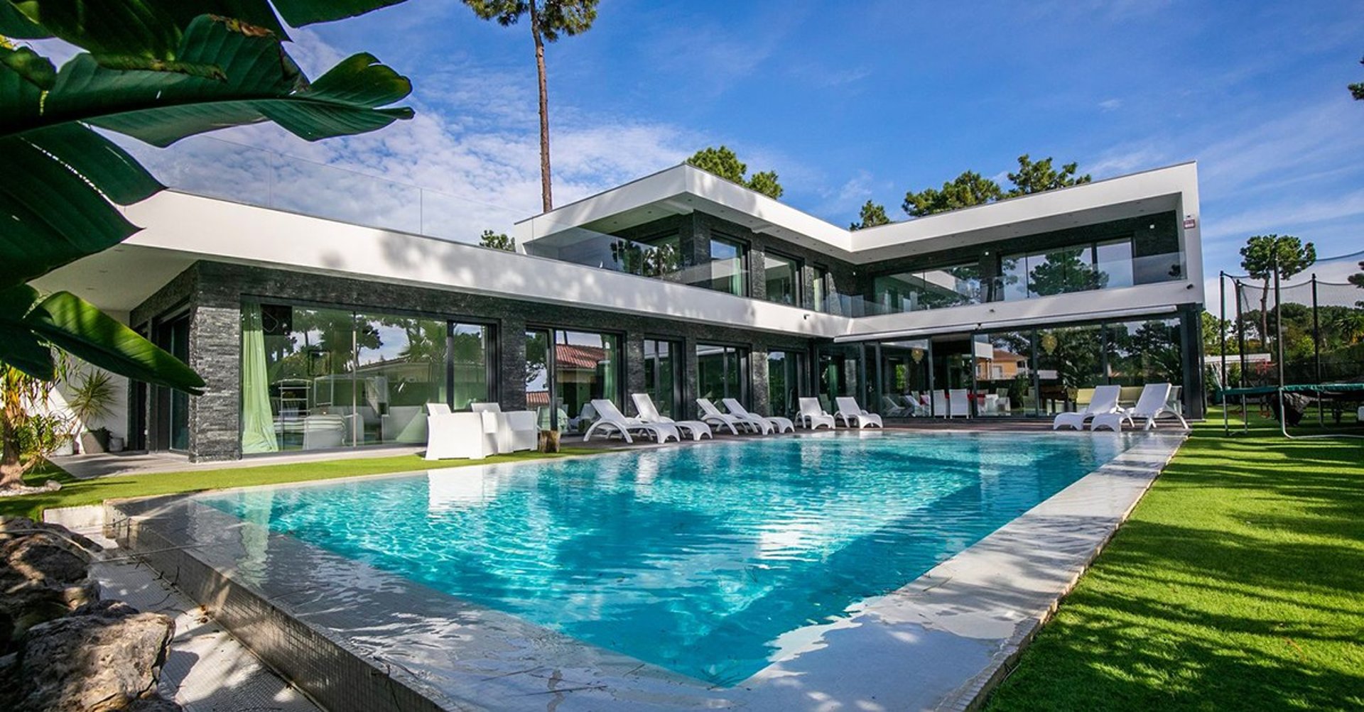A black and white photo of a building with palm trees