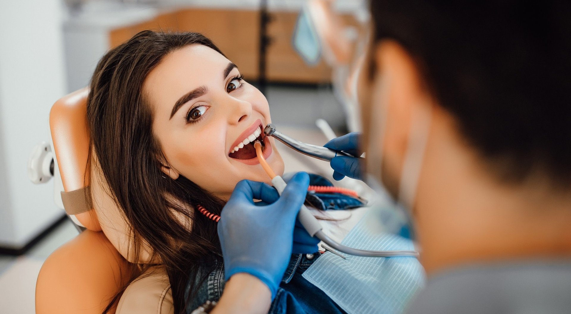 A young boy getting his teeth checked by a dentist
