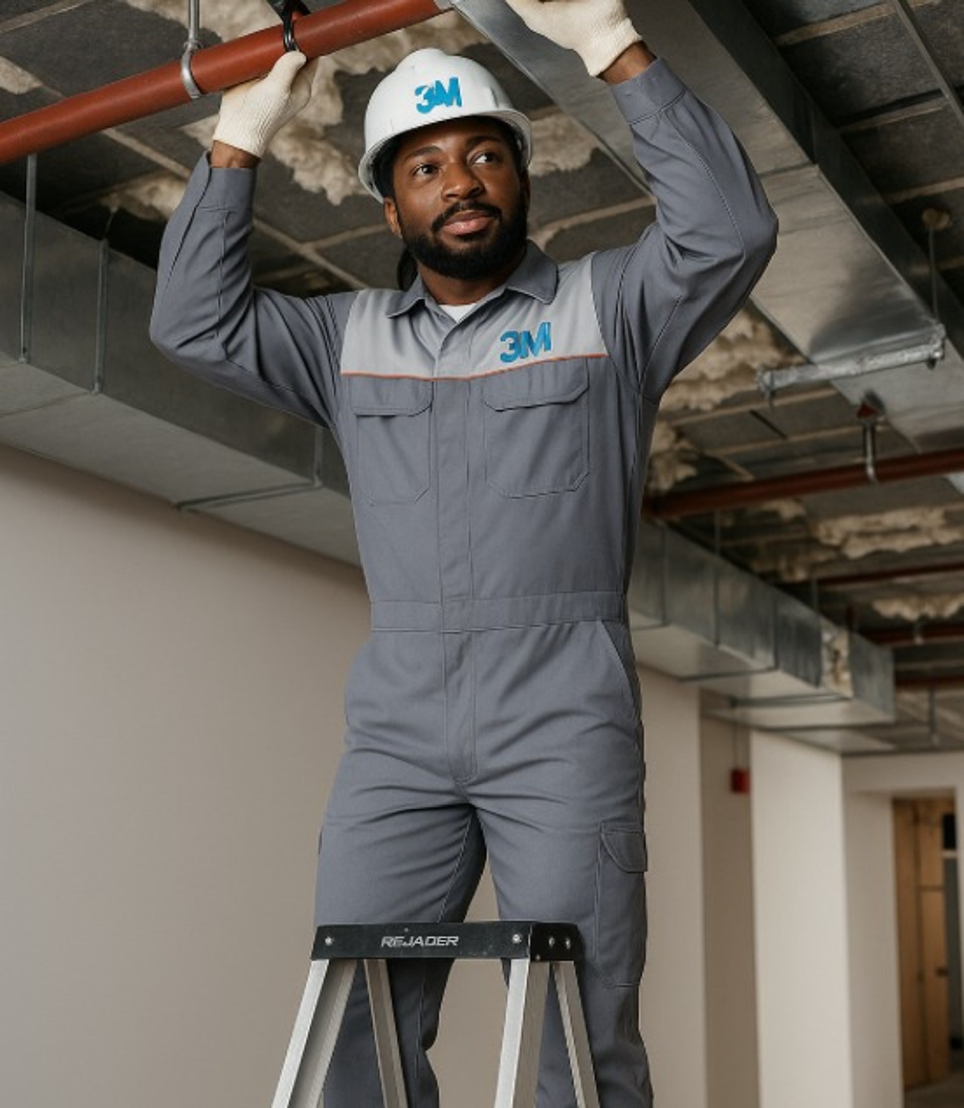 A man sanding a wooden table with a sander