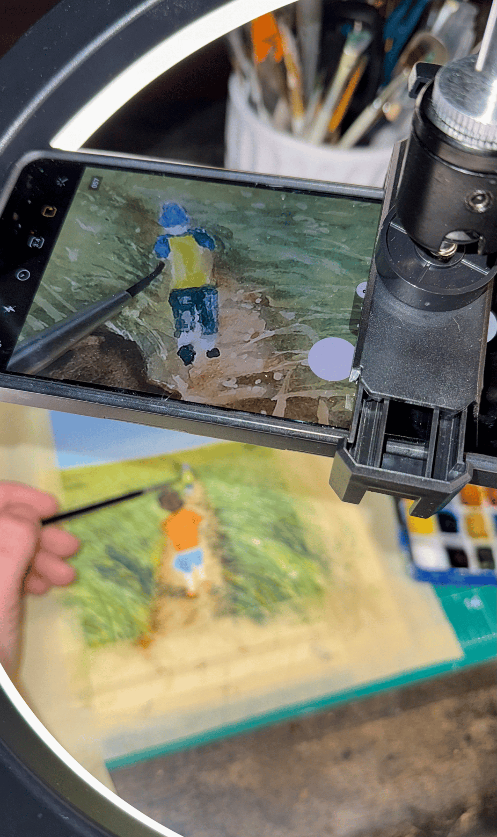 person holding paint brush while painting