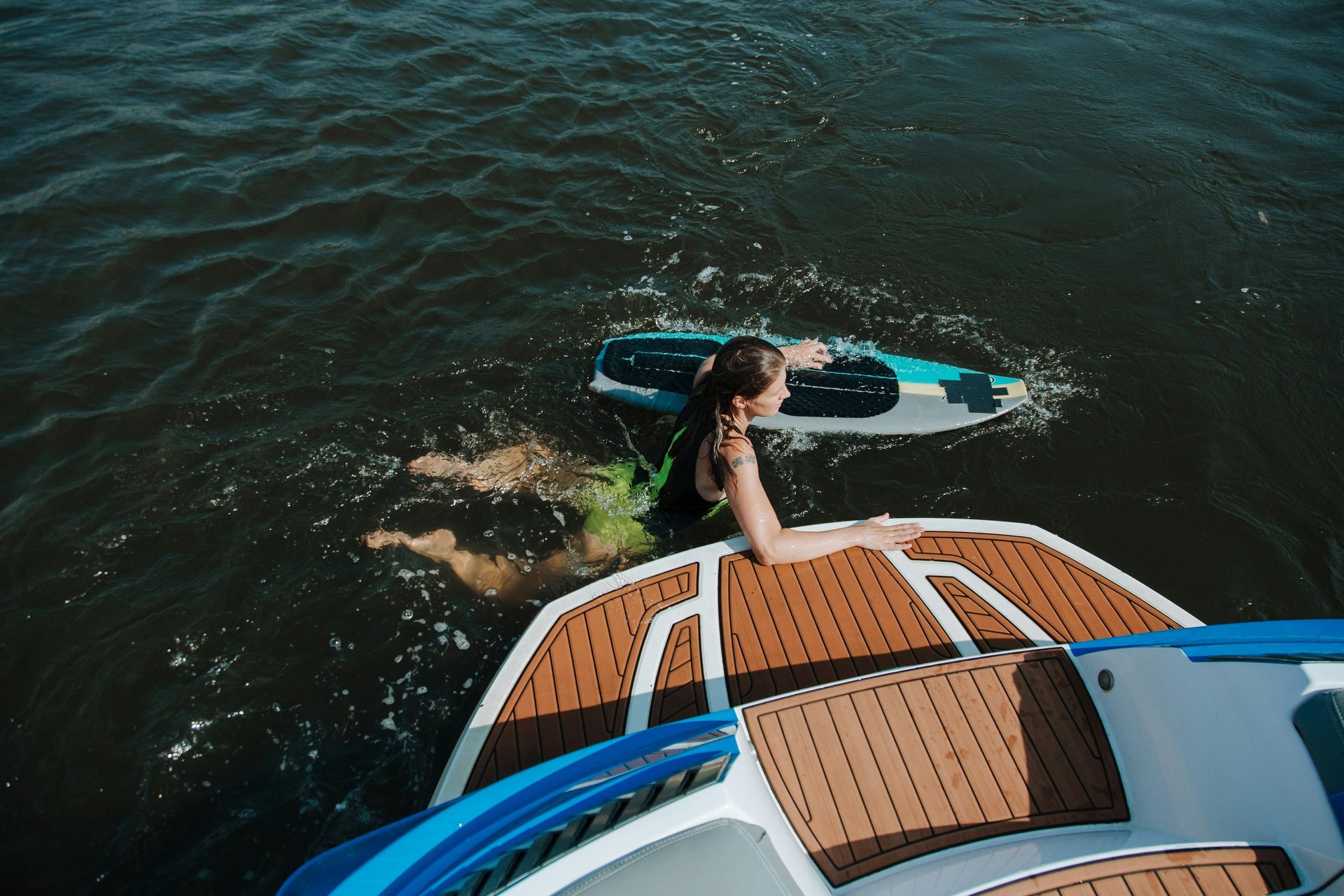 man in blue shorts on white and brown boat during daytime