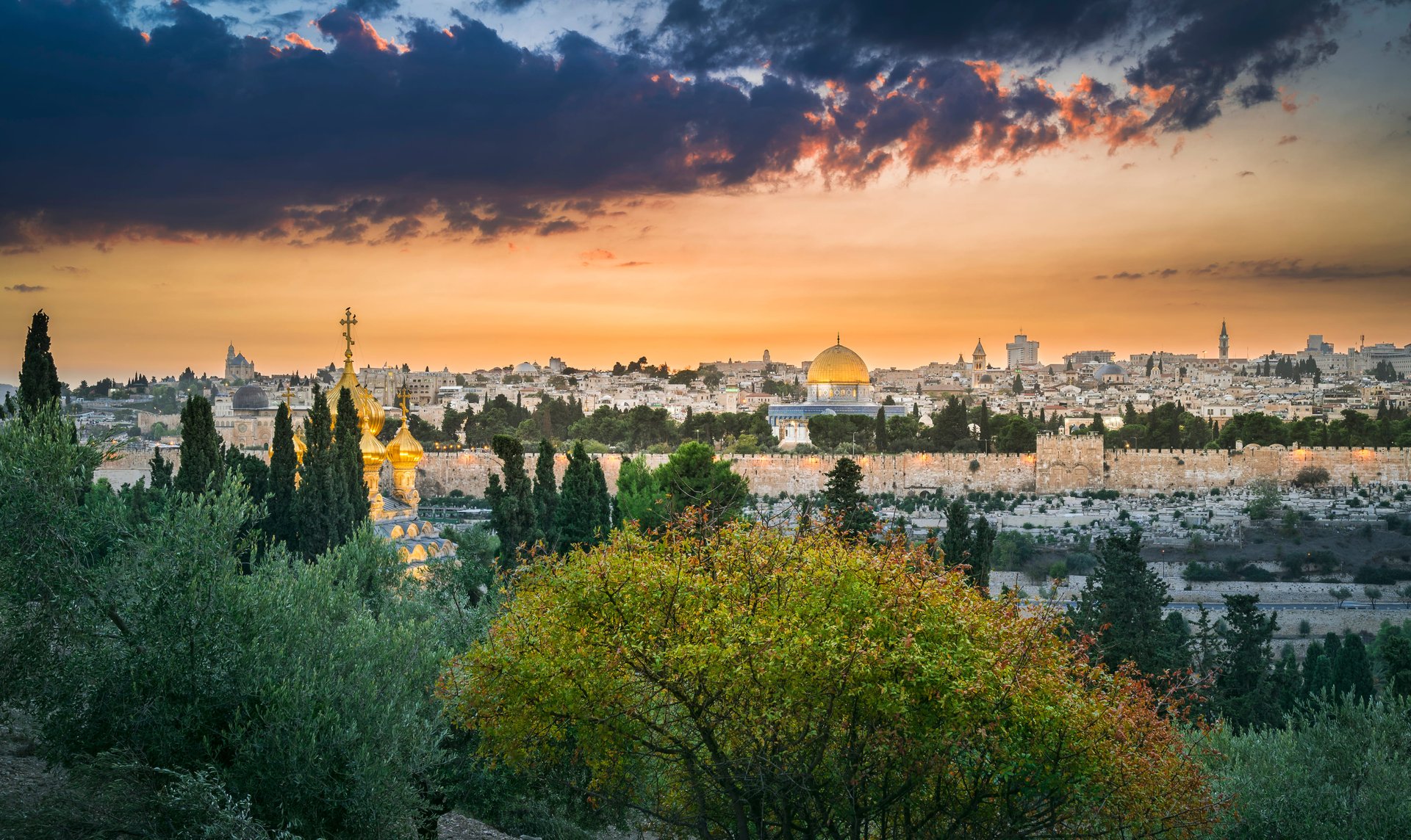 Sunset mountaintop view of the city of Jerusalem, with the golden Dome of the Rock visible