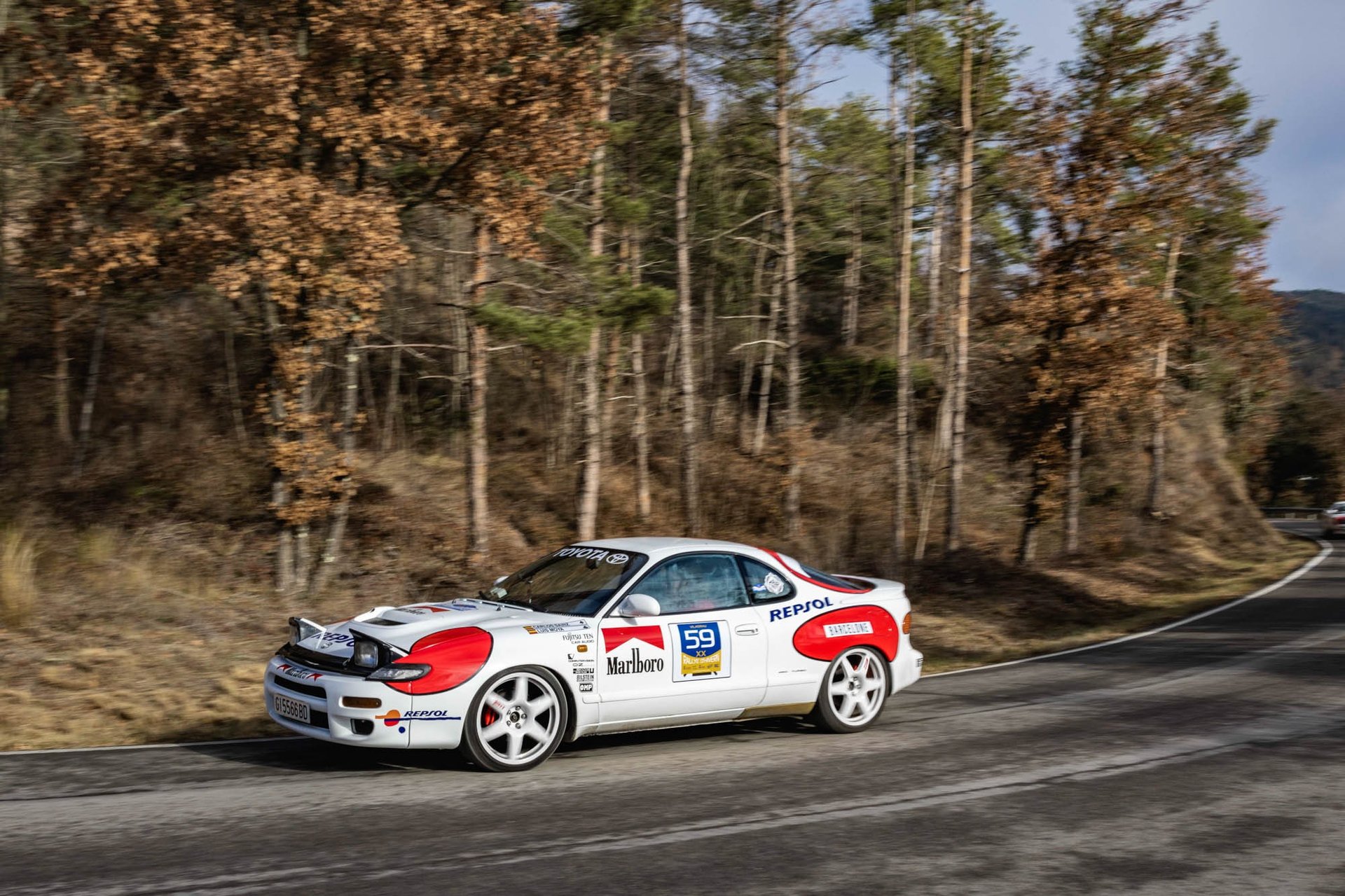 person riding on skis during winter surrounded by mountains