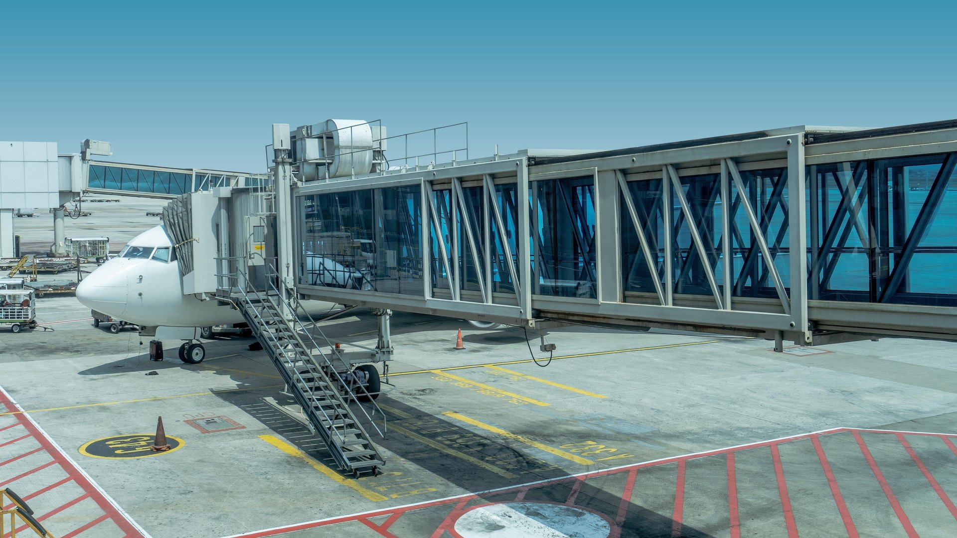 white airplane parked during daytime