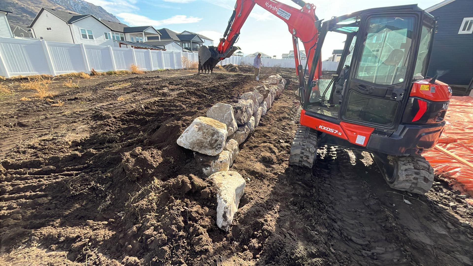 Kubota KX057-s excavator building rock boulder wall