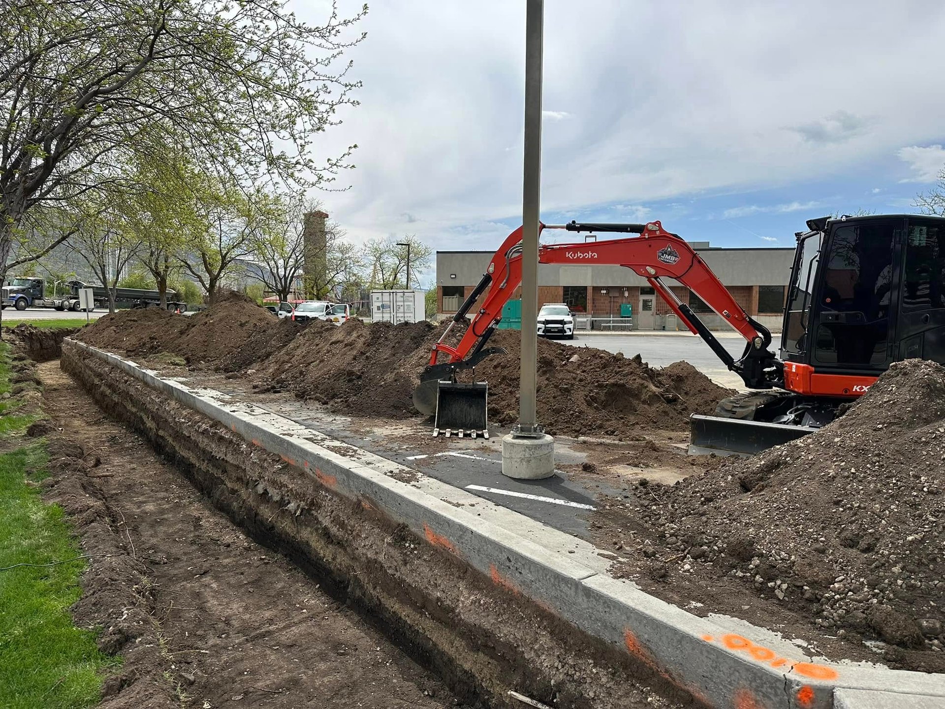 Kubota excavator digging at commericial property in northern Utah