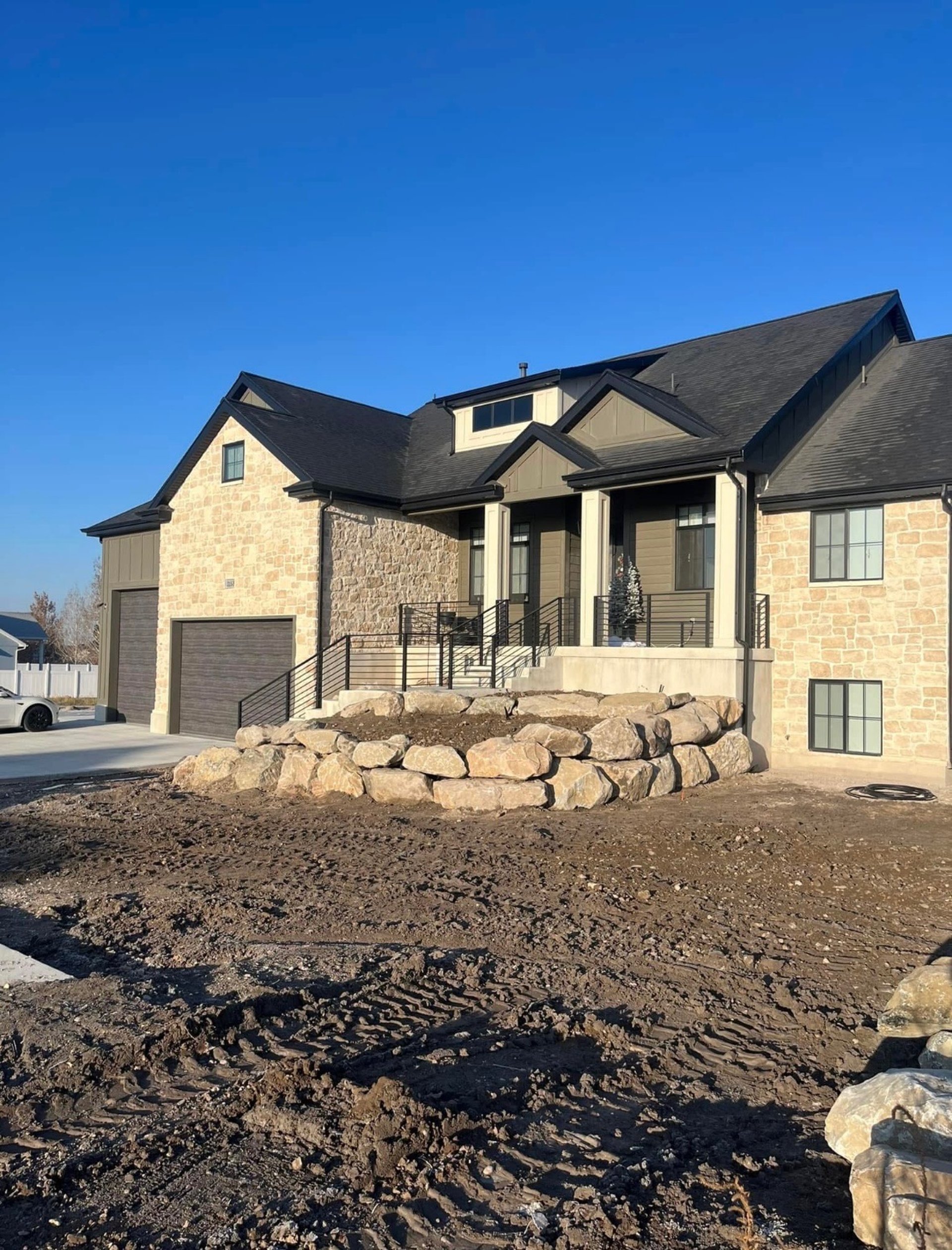 Boulder wall by front entry of home