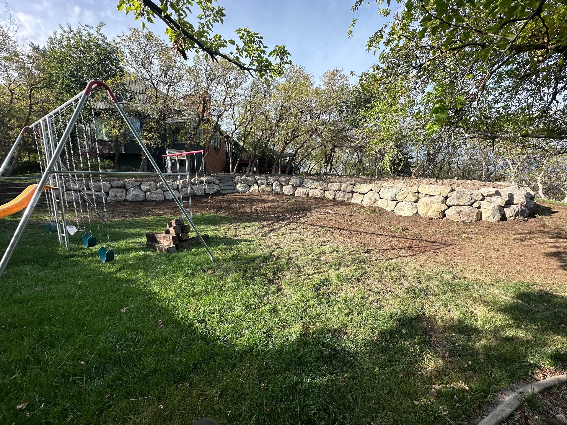 boulder wall completed in residential backyard 