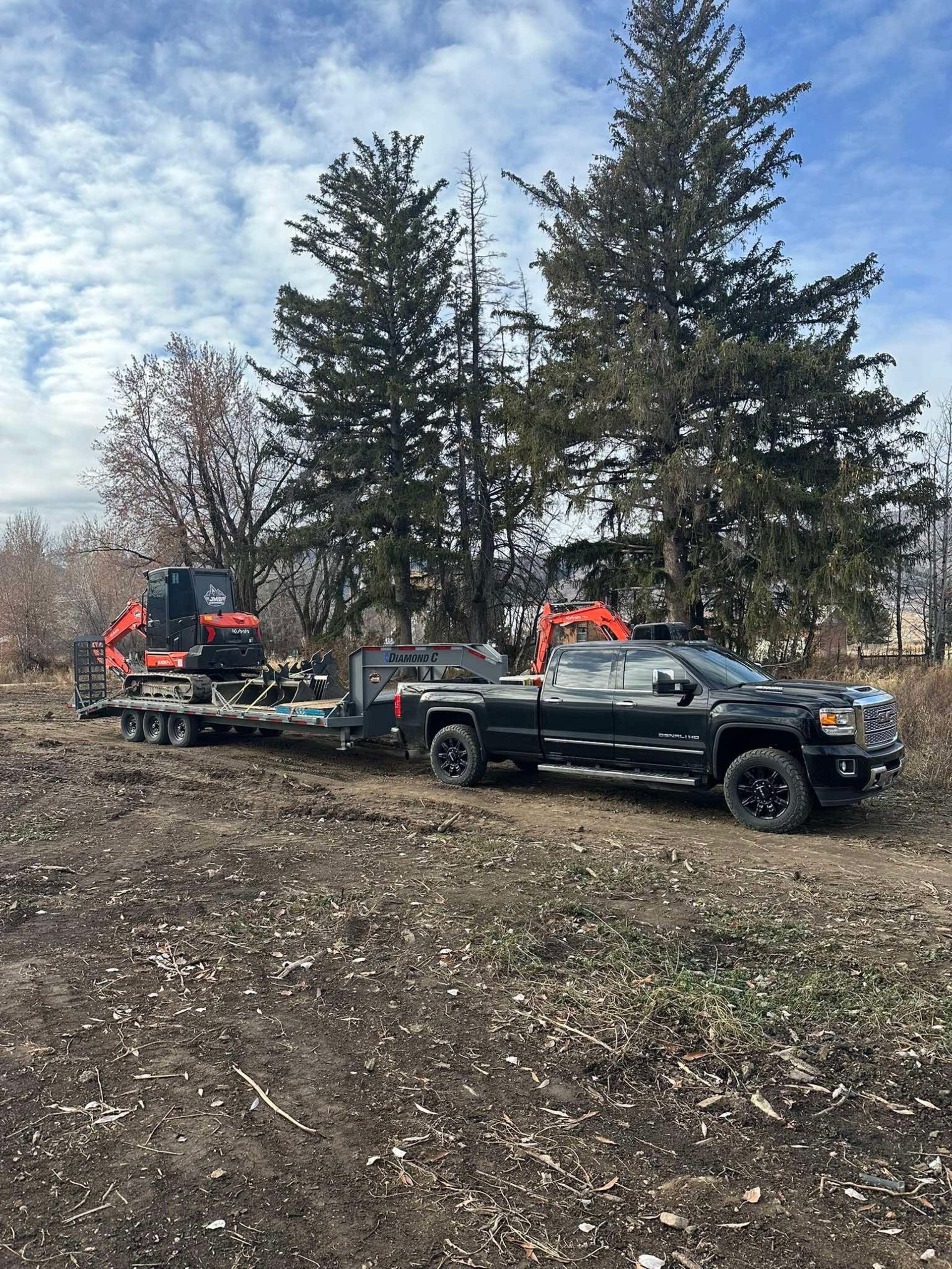 JMB Earthwork's truck and trailer hauling equipment