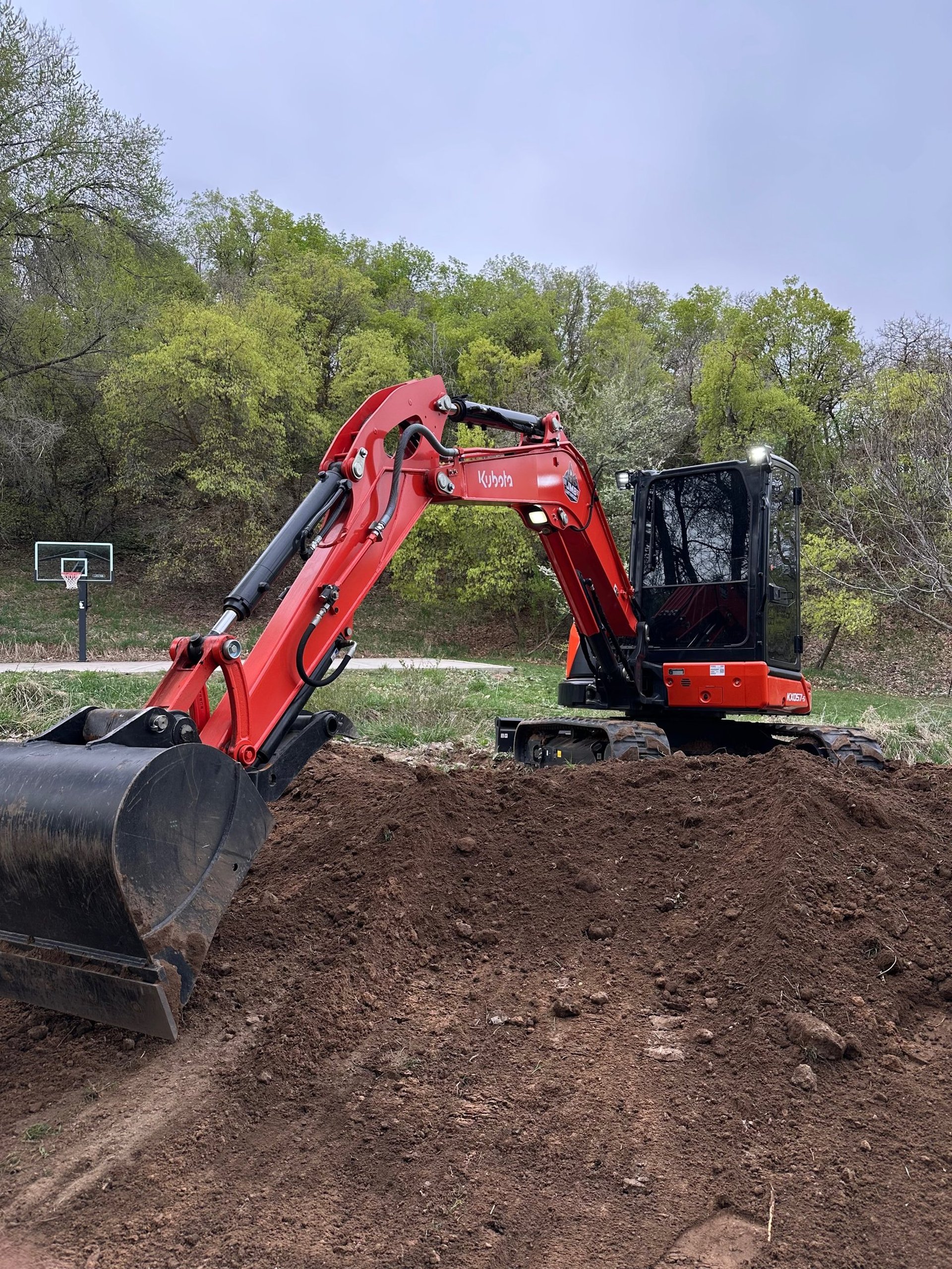 Kubota excavator digging dirt on project in northern Utah