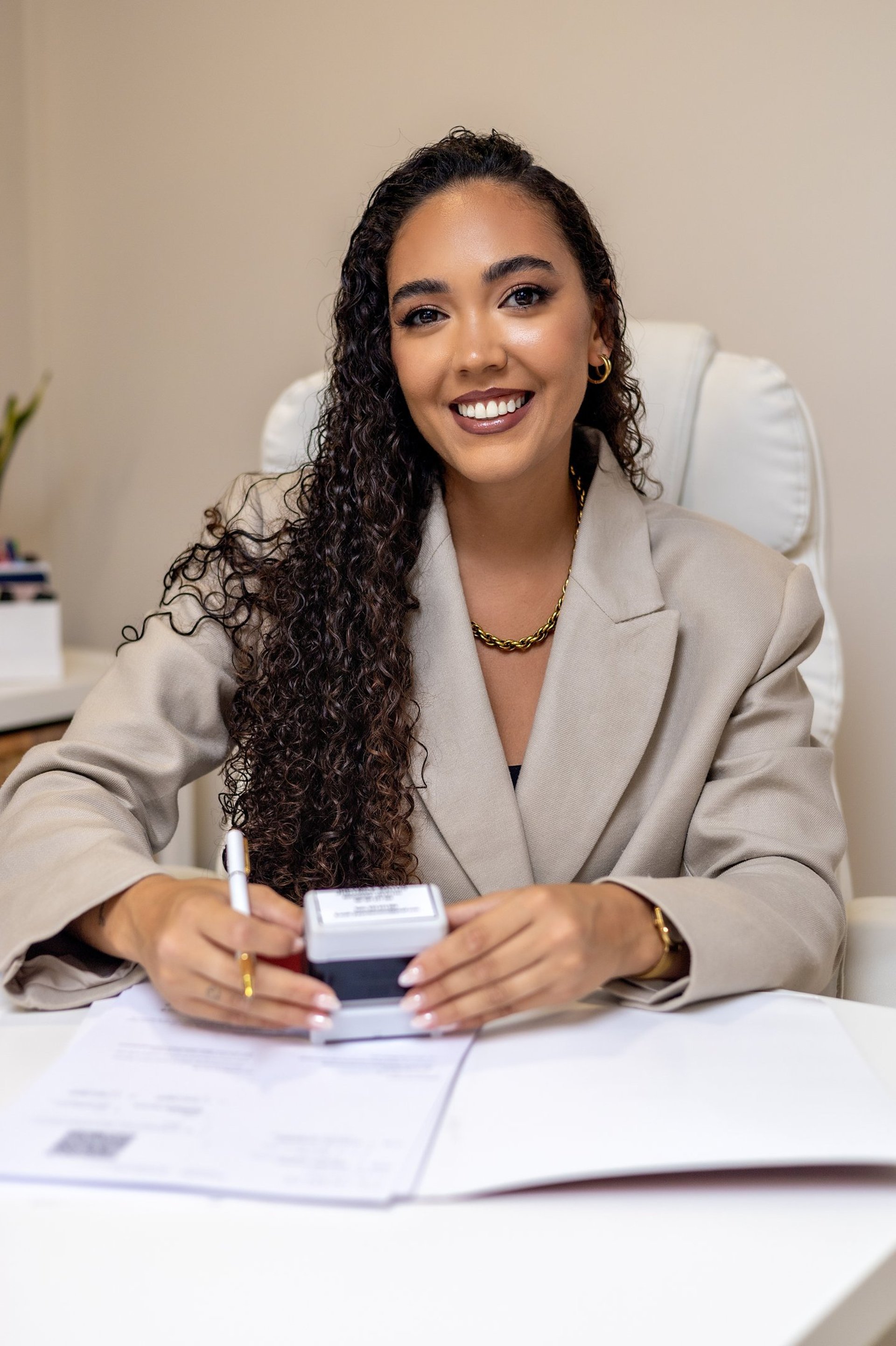 two people shaking hands in front of a laptop