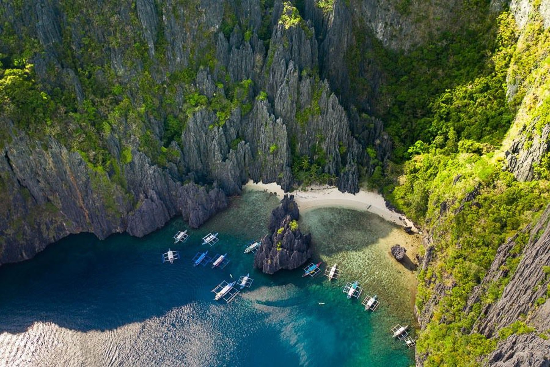 El Nido Tour A: boat at hidden lagoon surrounded by lush cliffs - top Philippines travel destination