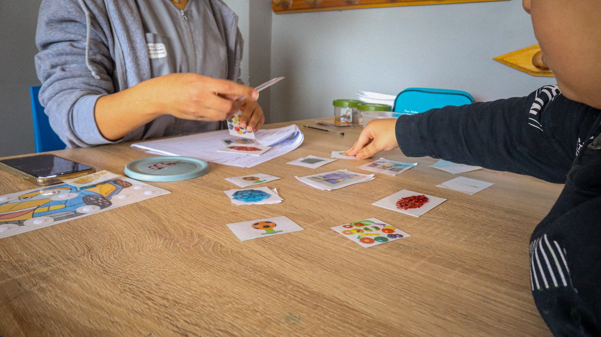 2 women sitting on chair in front of table