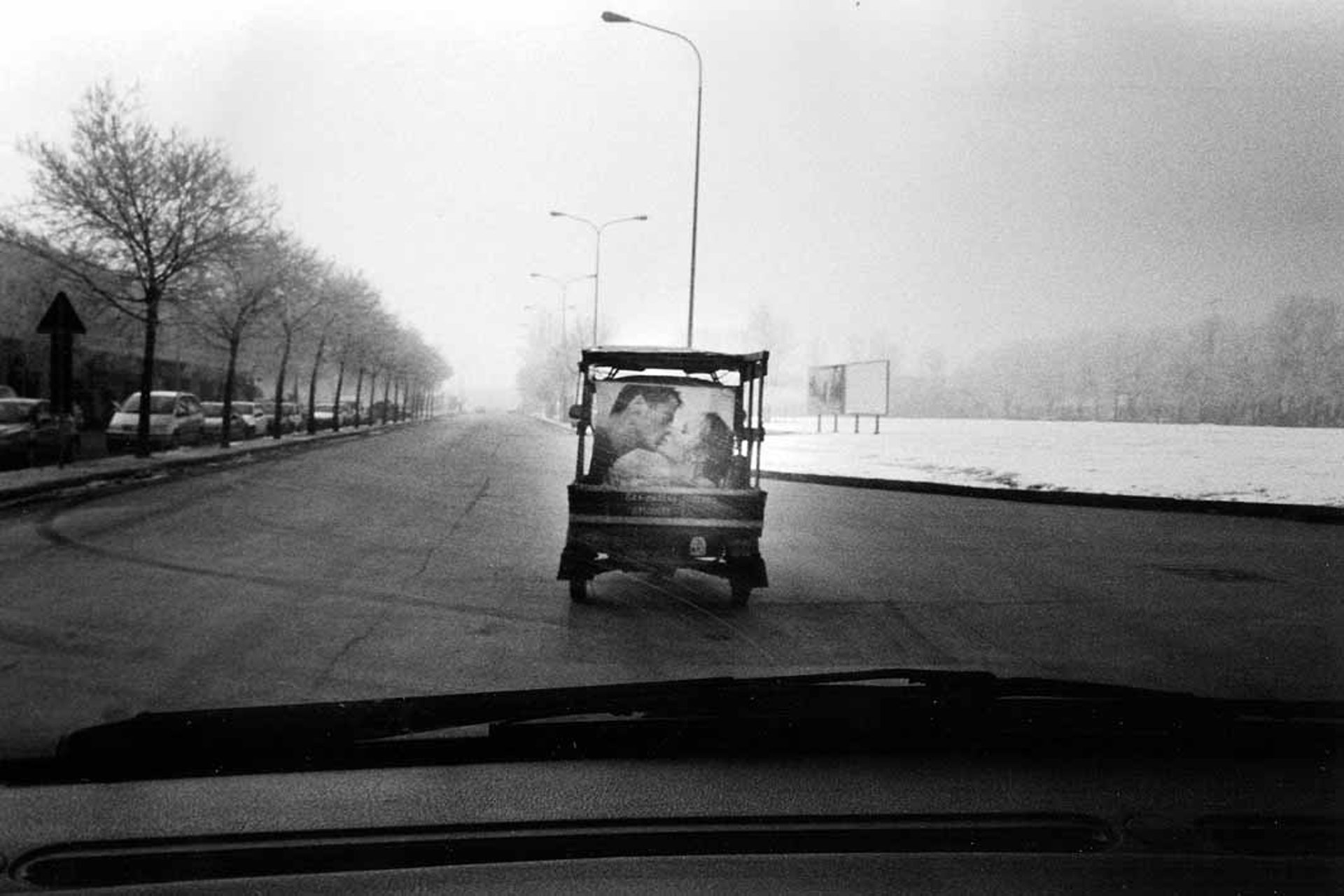 black and grey DSLR camera near several photos on brown map