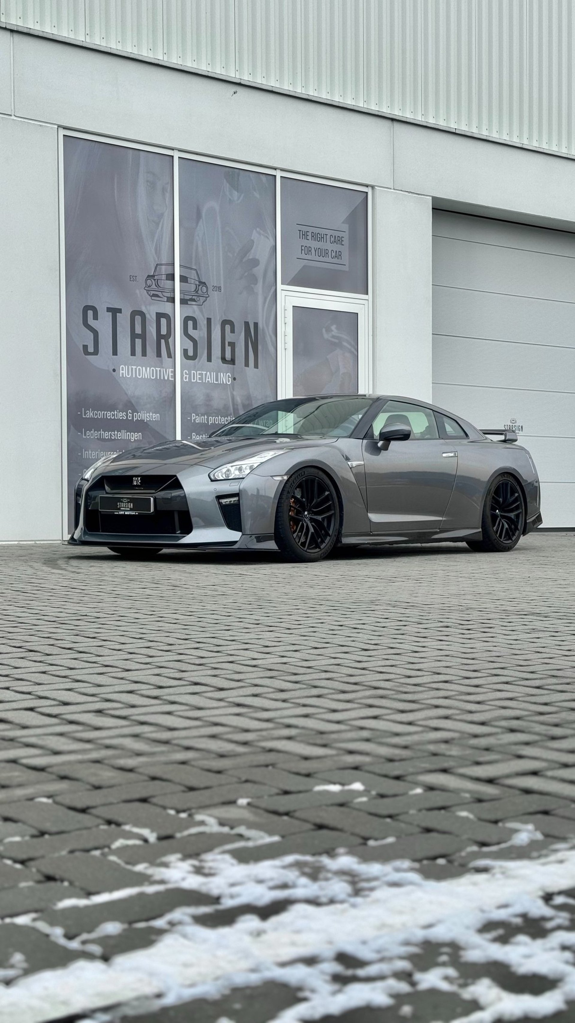 a black sports car parked in a garage