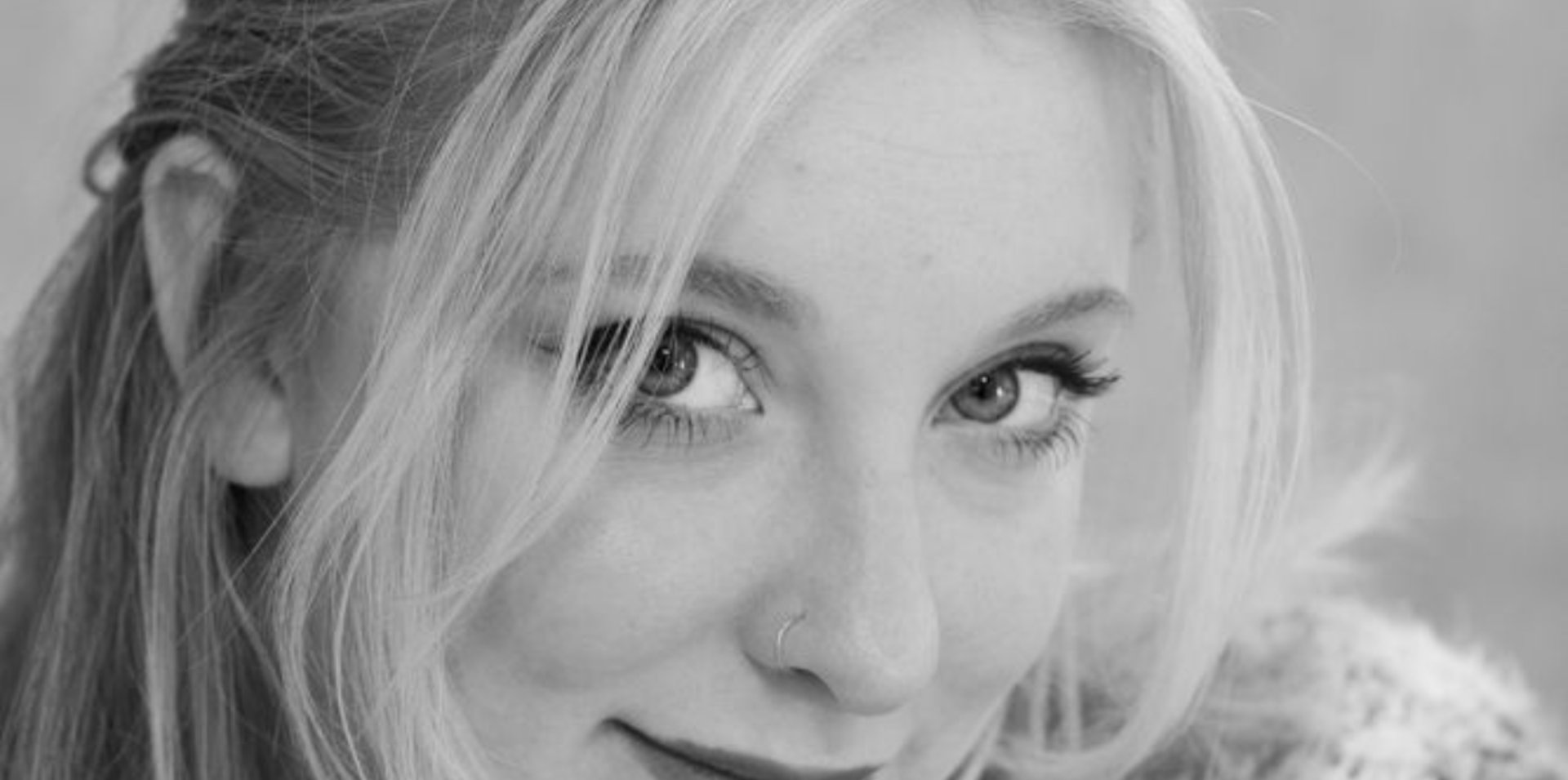 an abstract photo of a curved building with a blue sky in the background