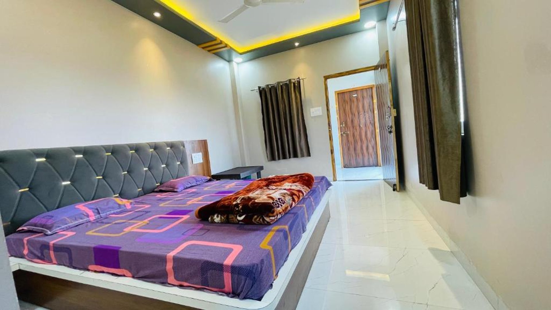 gray table lamp beside white bed pillow