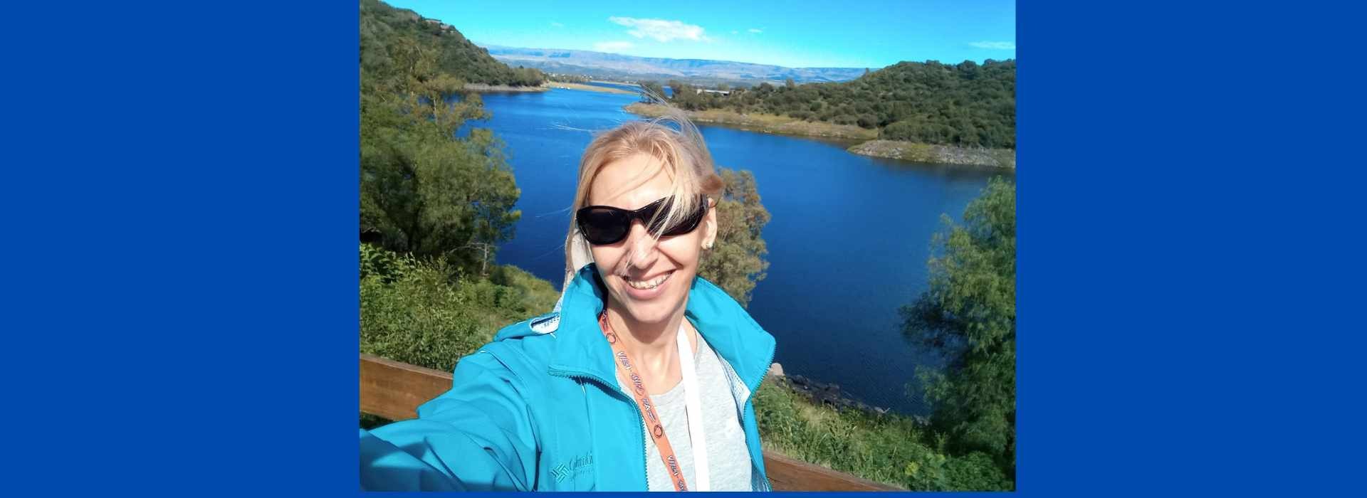 woman wearing yellow long-sleeved dress under white clouds and blue sky during daytime