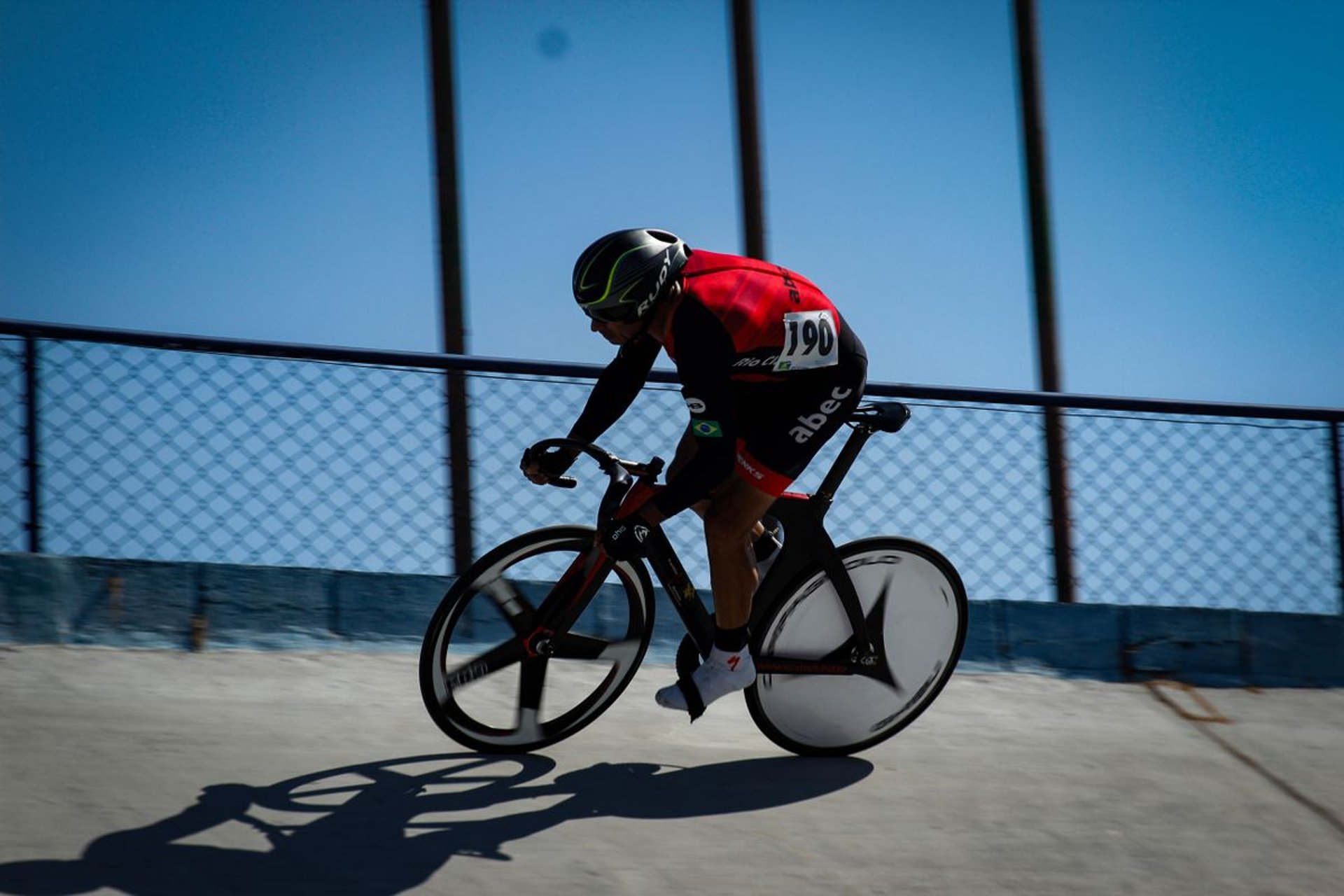 a man riding a bike on a tennis court
